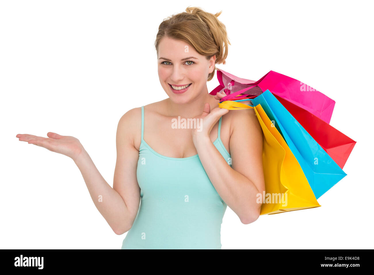 Donna sorridente presentando tenendo borse per lo shopping Foto Stock