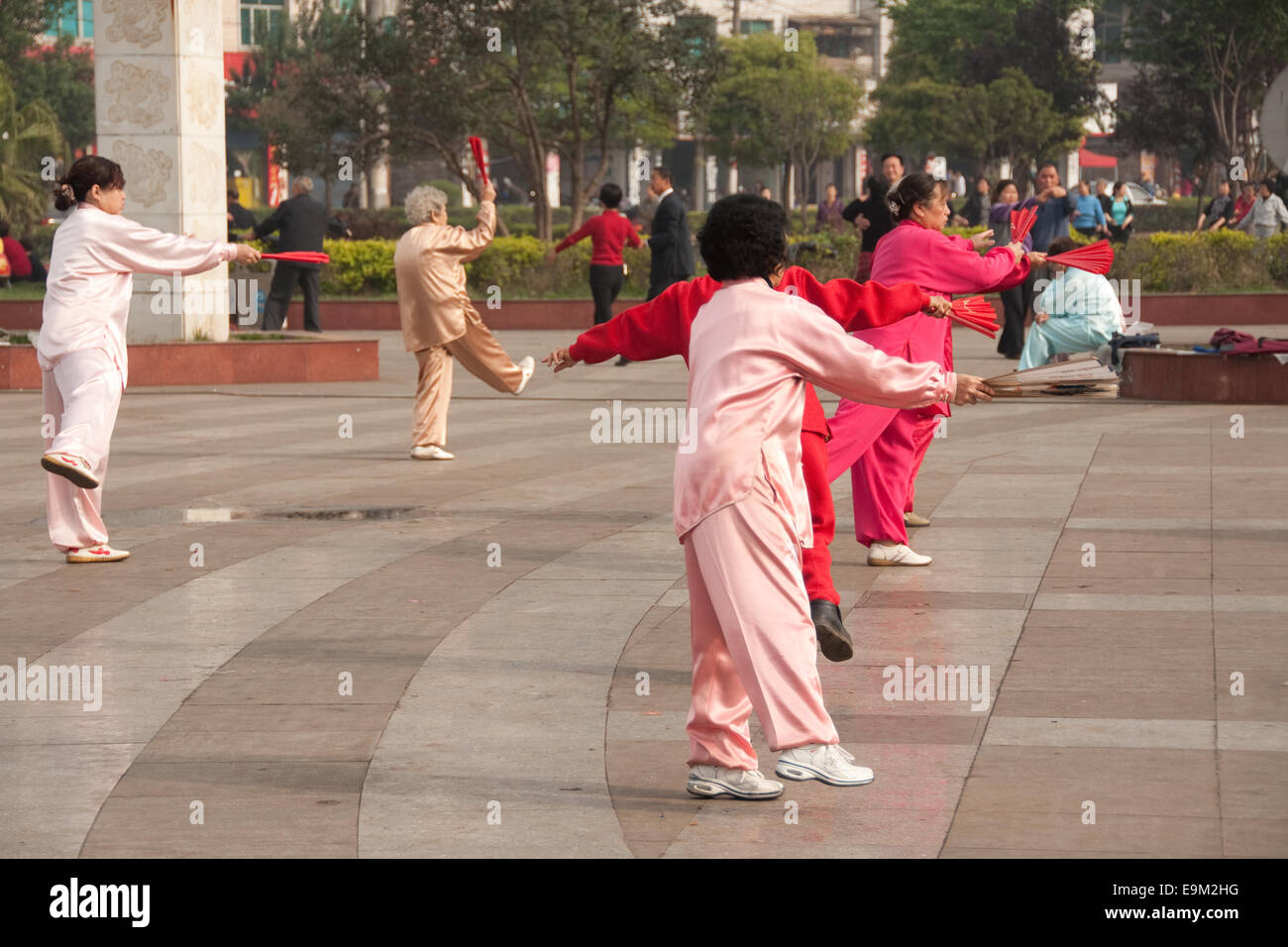 Le donne cinesi in rosa abito in seta ballando con ventole, luzhi, guizhou, Cina Foto Stock