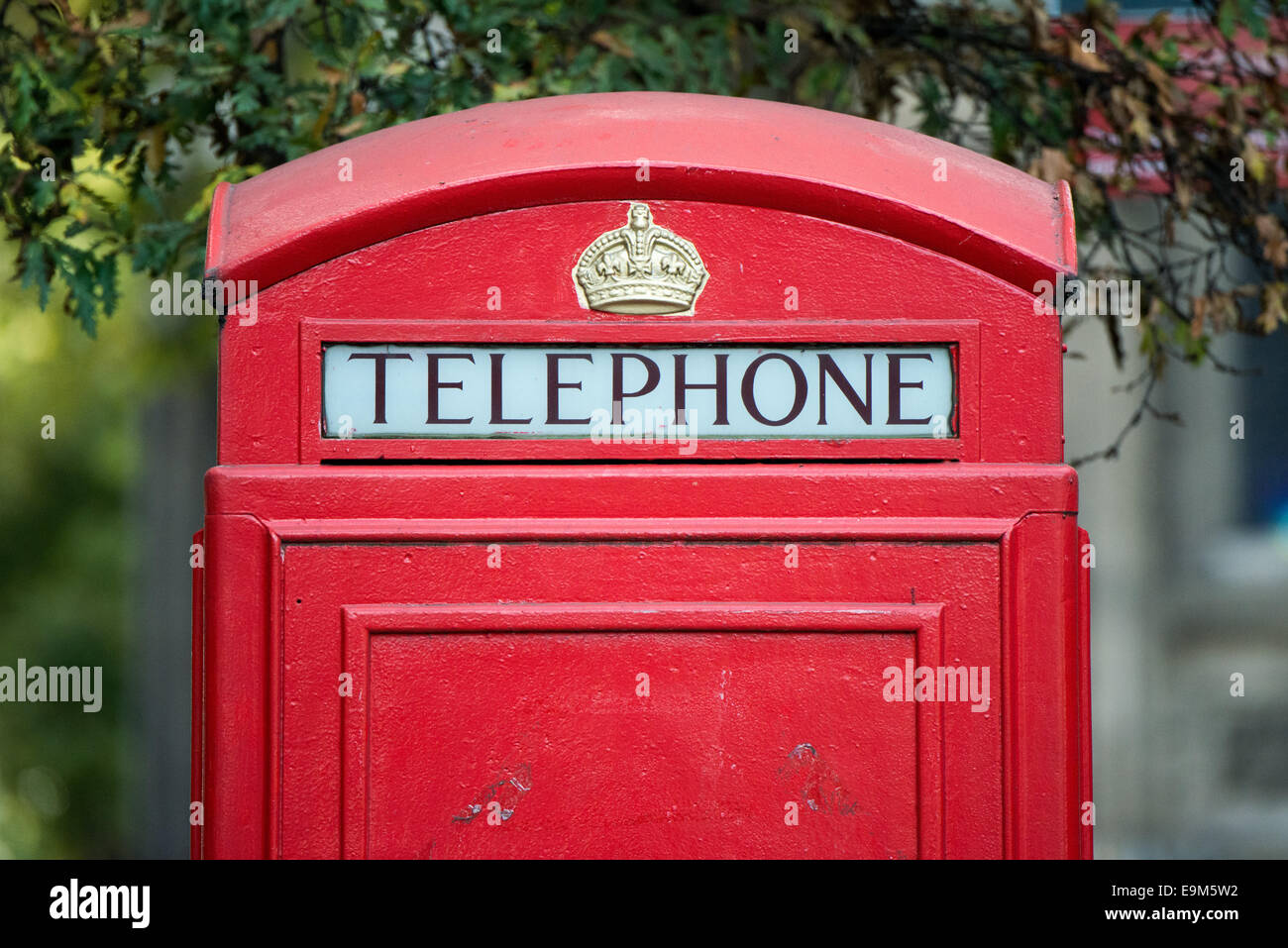 Red Telephone Box Londra Regno Unito // LONDRA, Regno Unito — Un classico telefono rosso si trova su una strada di Londra, che funge da simbolo iconico del patrimonio britannico. Progettati da Sir Giles Gilbert Scott negli anni '1920, questi distintivi chioschi K6 divennero sinonimo di paesaggi urbani britannici per tutto il XX secolo. Sebbene in gran parte obsoleto nell'era della telefonia mobile, molti di questi storici stand sono stati conservati come punti di riferimento protetti o riutilizzati per usi alternativi. Il colore rosso brillante e le insegne a corona rendono queste scatole telefoniche immediatamente riconoscibili in tutto il mondo e una popolare S Foto Stock