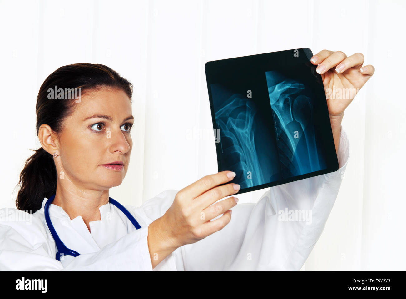 Giovane medico nel suo studio medico con un x-ray Foto Stock