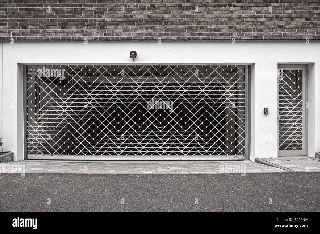 Ingresso di un garage per il parcheggio, chiuso con una porta sbarrata. Foto Stock