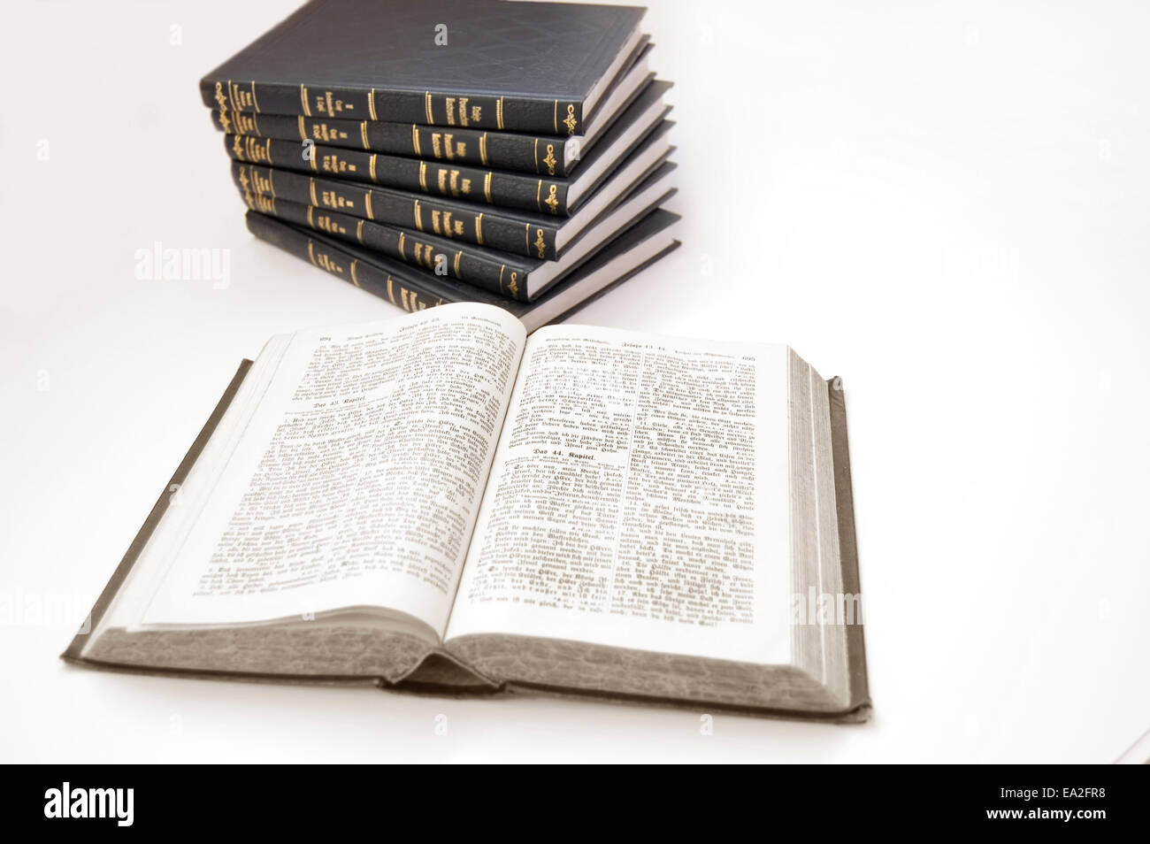 La Bibbia immagine concettuale. La Bibbia e altri libri sullo sfondo isolato. Foto Stock