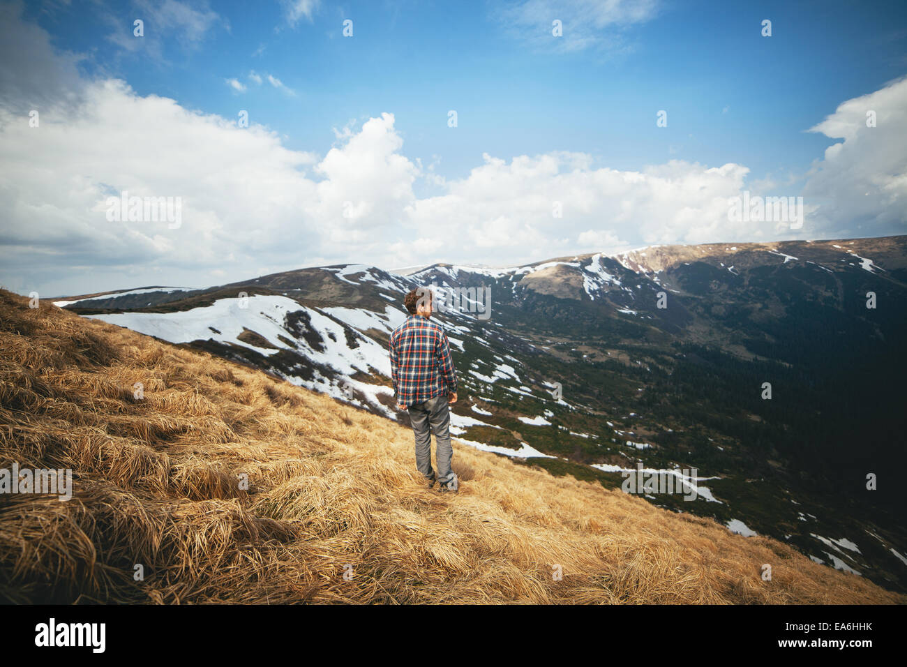 Giovane uomo in piedi in campo e cercando di visualizzare Foto Stock