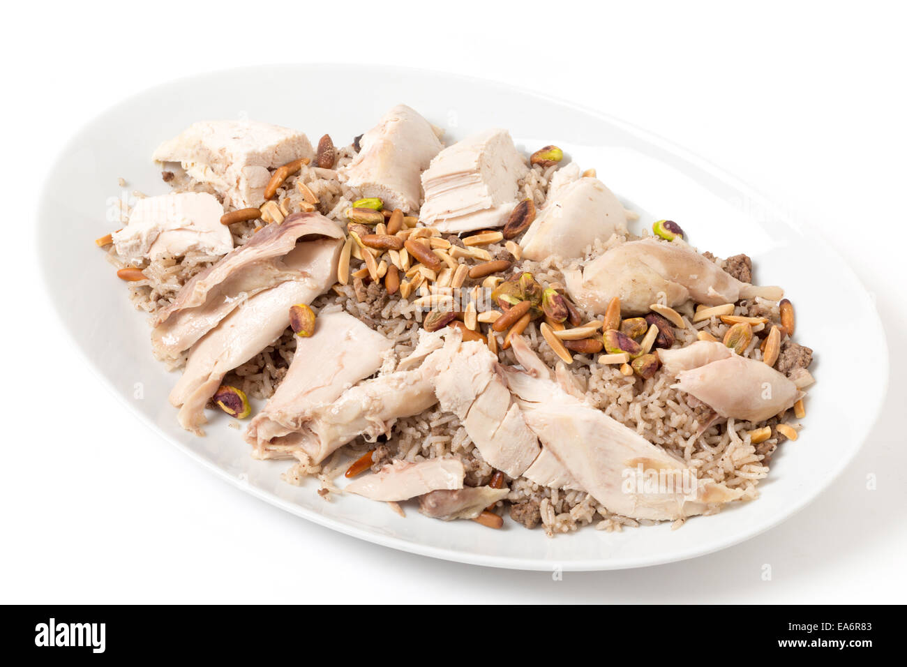 Piatto di pollo libanese e speziato di riso con carne arrosto e dadi, una specialità per le celebrazioni del Levante Foto Stock