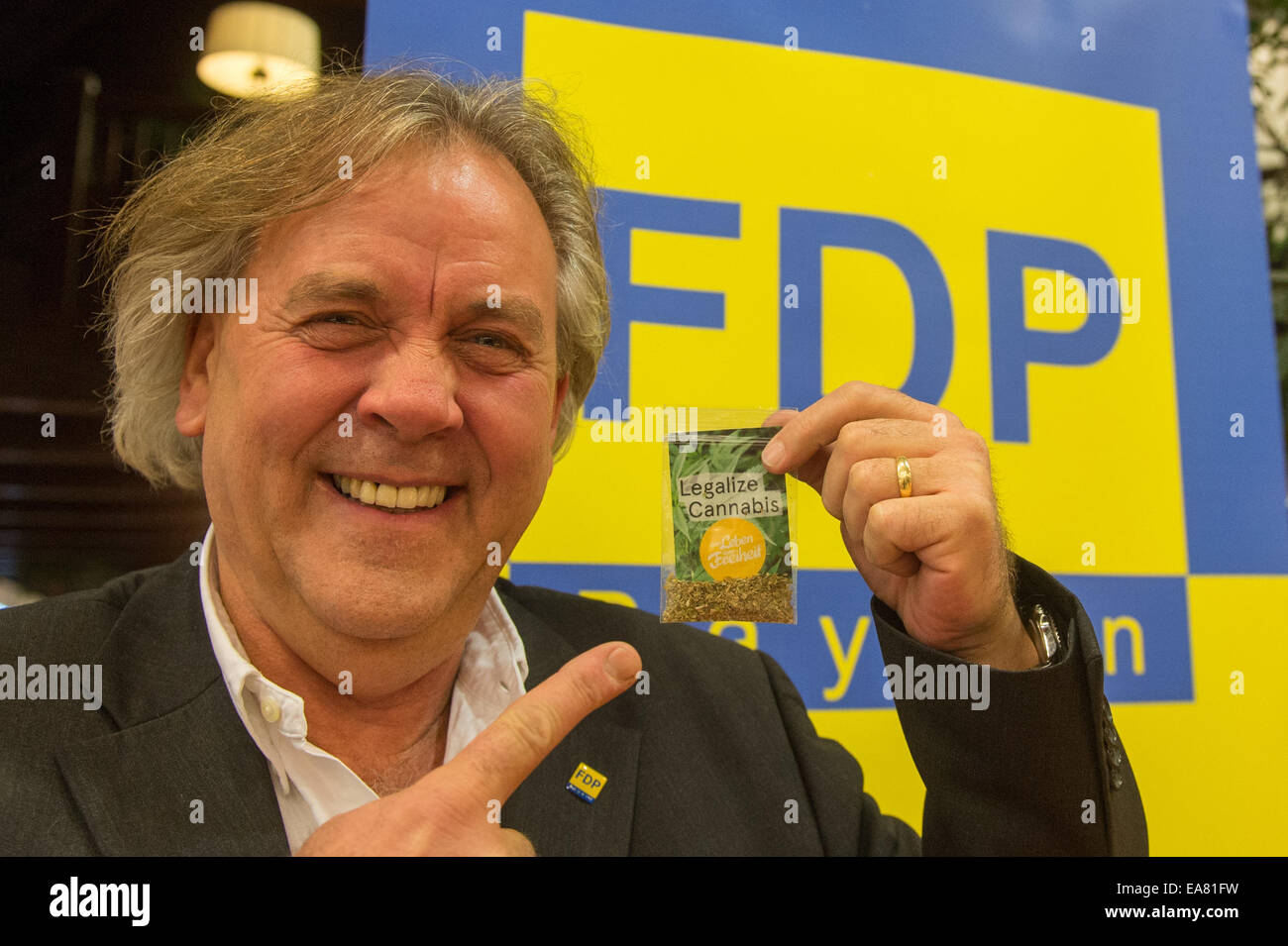 Bad Fuessing, Germania. 08 Nov, 2014. Il capo del Partito Democratico Libero (FDP) della Repubblica federale di Germania in Baviera, Albert Duin, sorregge un sacco di erbe che dice "legalizzare la cannabis' presso il Bavarian FDP Partito in Bad Fuessing, Germania, 08 novembre 2014. I partecipanti saranno in grado di decidere su una proposta di legalizzare la cannabis. La conferenza dovrebbe mettere in moto un nuovo inizio. Foto: ARMIN WEIGEL/dpa/Alamy Live News Foto Stock