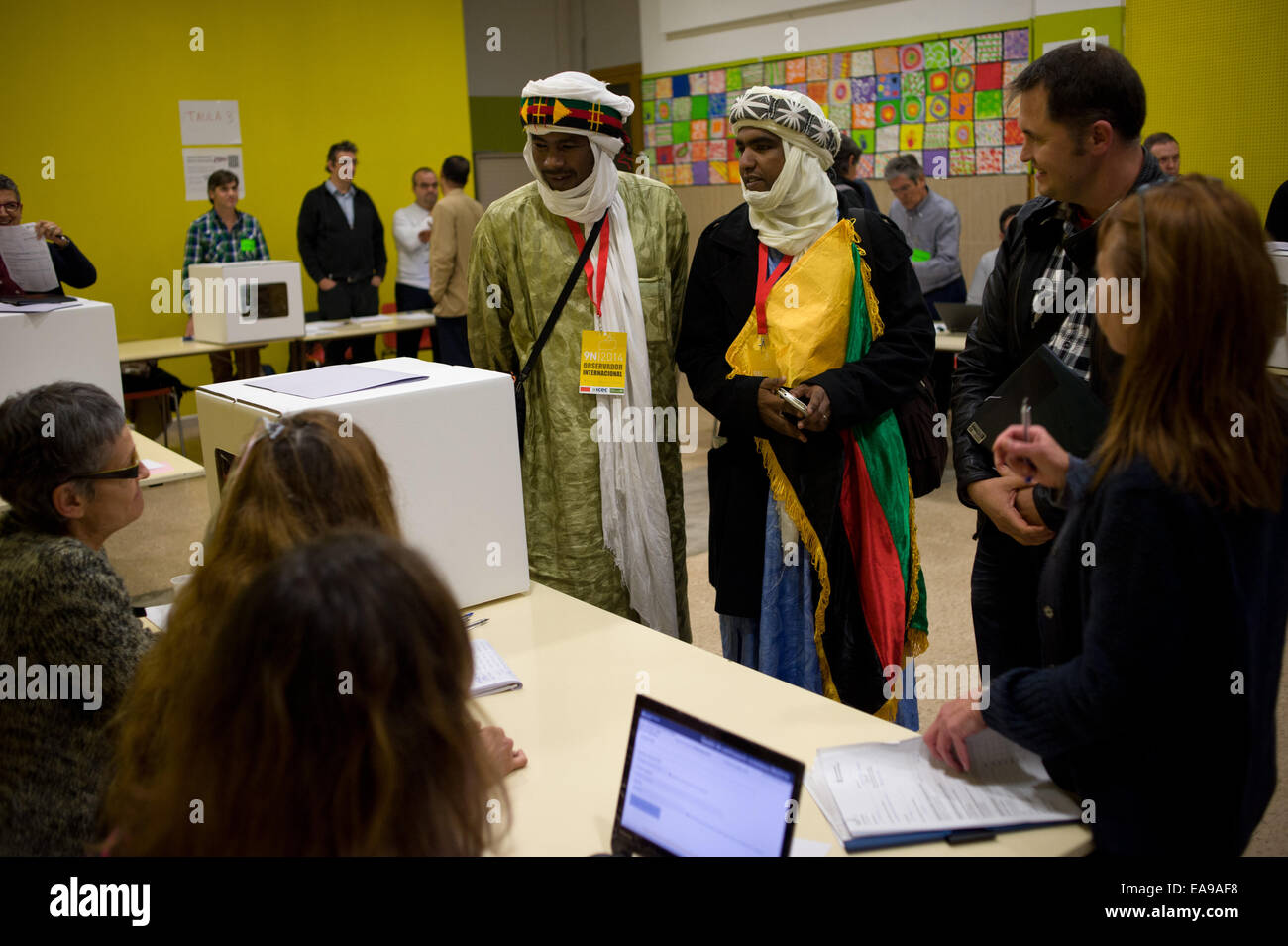 Barcellona, in Catalogna, Spagna. 9 Nov, 2014. I membri di una delegazione di osservatori internazionali provenienti da Azawad (nord Mali) salutare i membri di un seggio in Barcellona. La Catalogna del governo di fasi di un simbolico il polling sulla secessione in una mostra di determinazione e di defiance dopo che la Corte costituzionale ha sospeso la sua intenzione di tenere un funzionario referendum di indipendenza a seguito di una azione legale da parte del governo spagnolo. © Jordi Boixareu/ZUMA filo/Alamy Live News Foto Stock