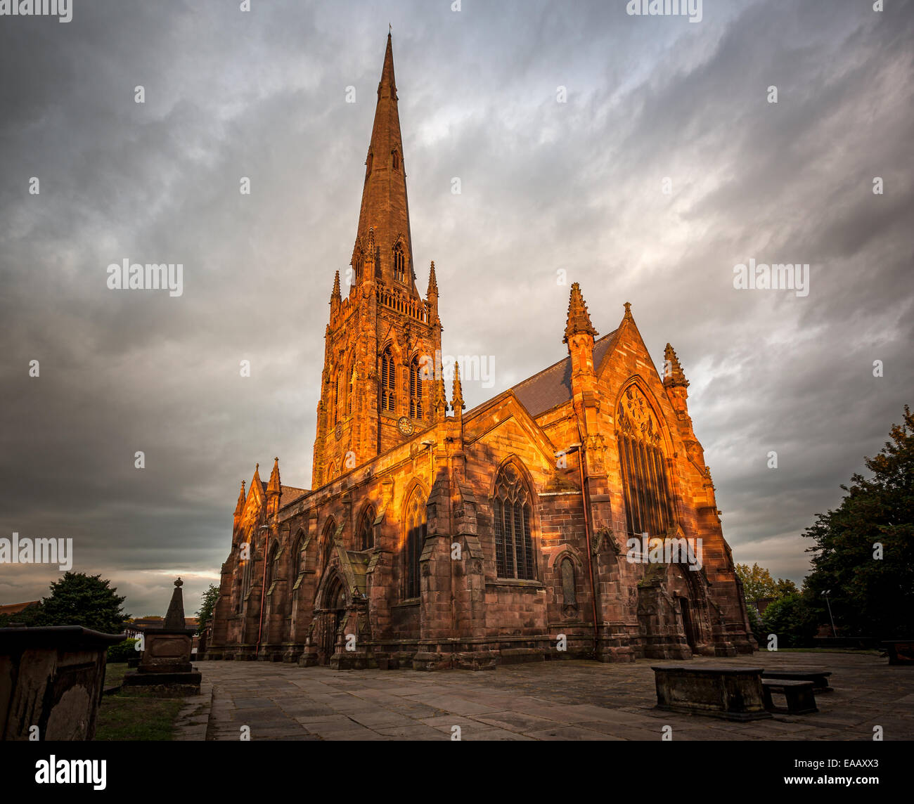 Chiesa in stile gotico illuminato nel colore dorato di impostazione di luce solare, Warrington, Cheshire, Regno Unito Foto Stock