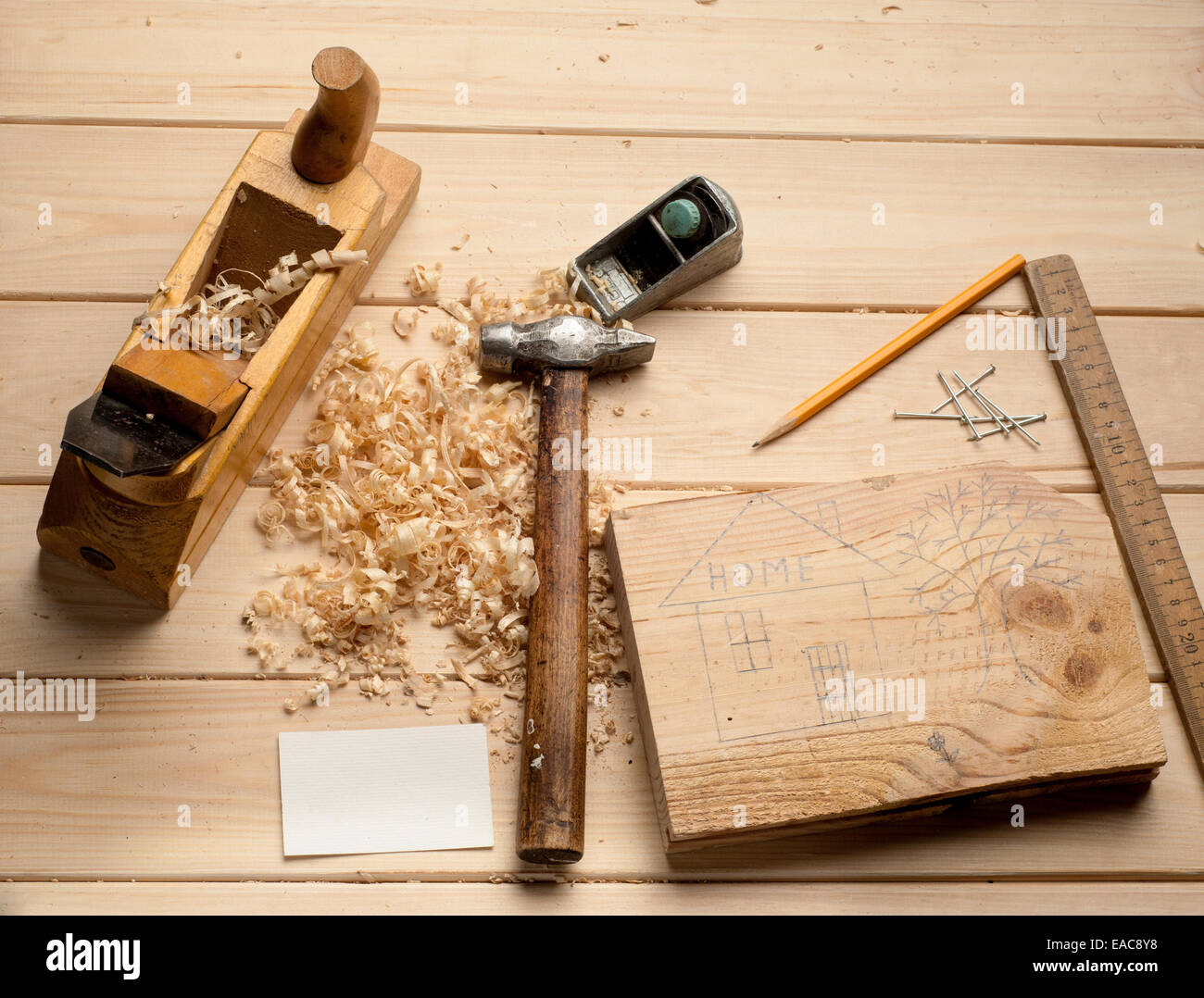 Falegname attrezzi,martello,metro, unghie, trucioli e piano su tavola di legno Foto Stock