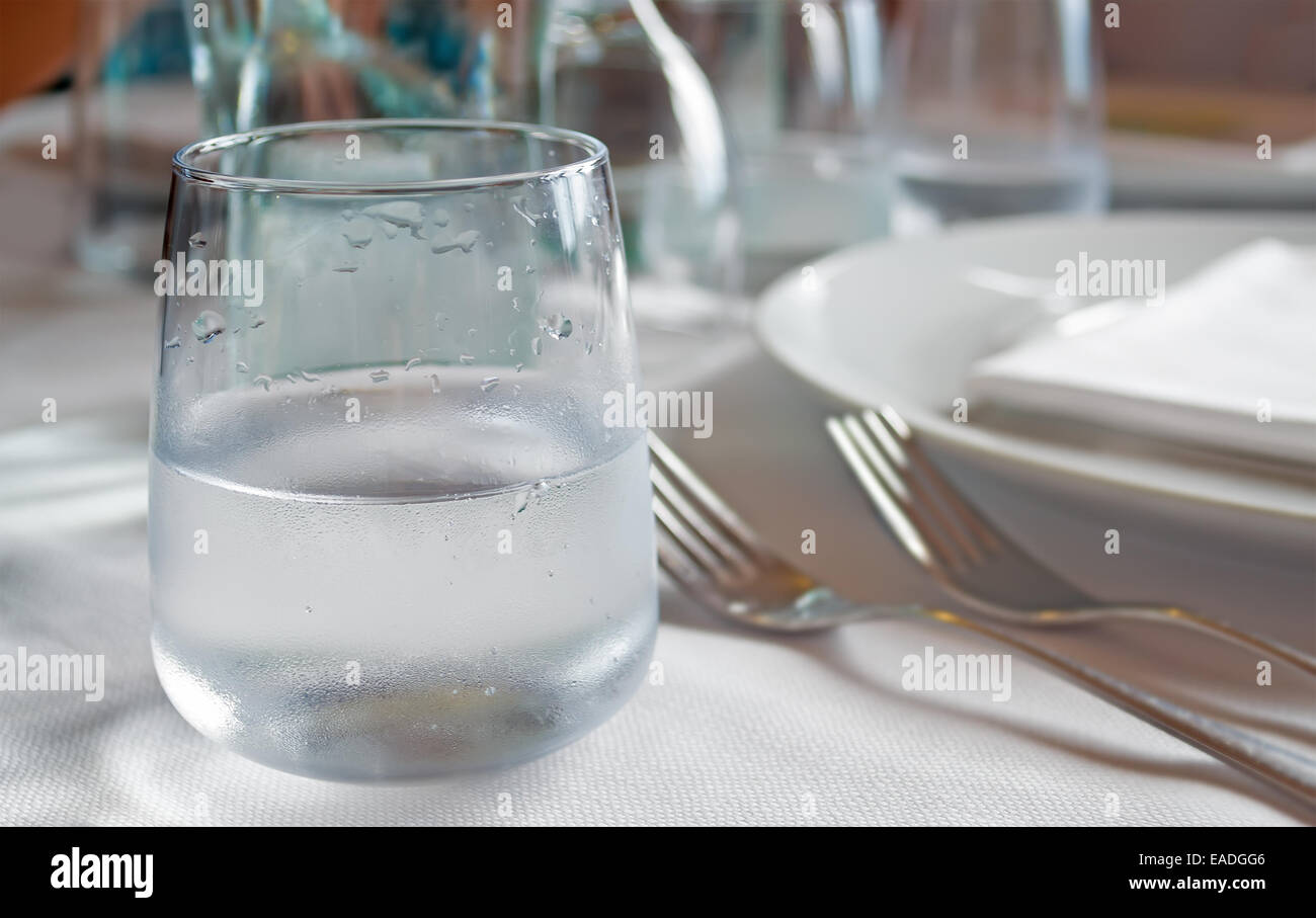 Bicchiere di acqua con goccia su di esso Foto Stock