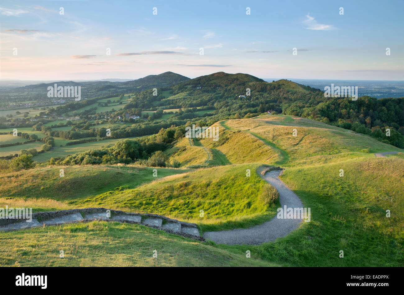 I bastioni della storica hill fort britannica di Camp, Herefordshire Beacon vengono illuminati con la forte luce del tramonto Foto Stock