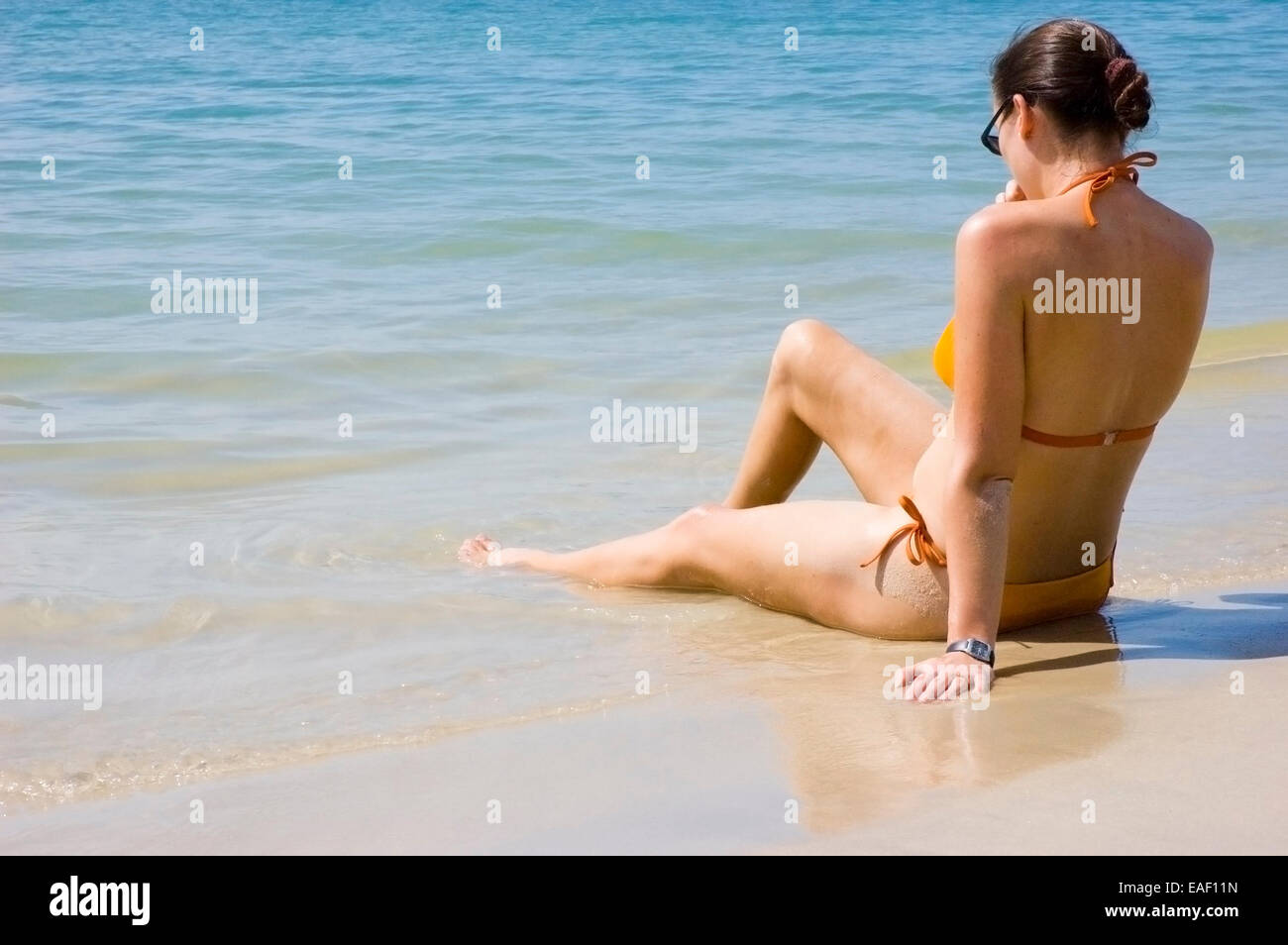 Giovane donna in bikini su una spiaggia Foto Stock
