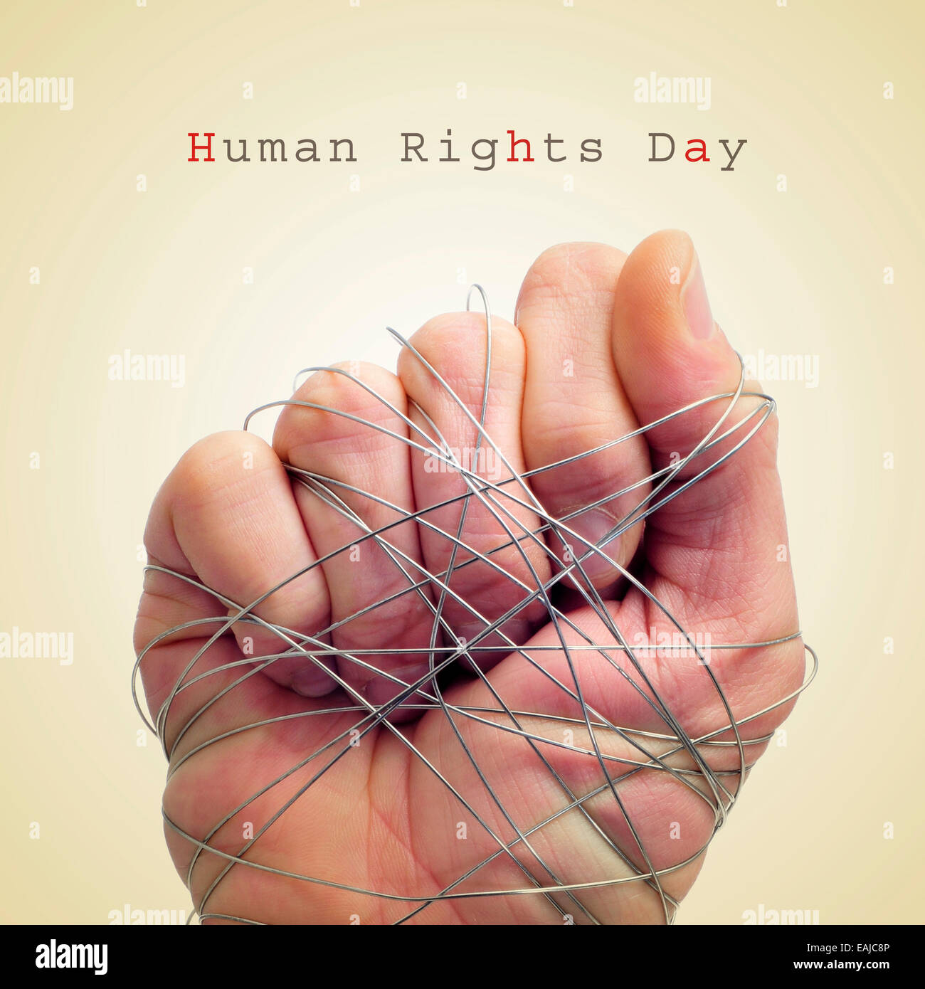 Un uomo legato a mano con il filo e il testo la giornata dei diritti umani su un sfondo beige Foto Stock