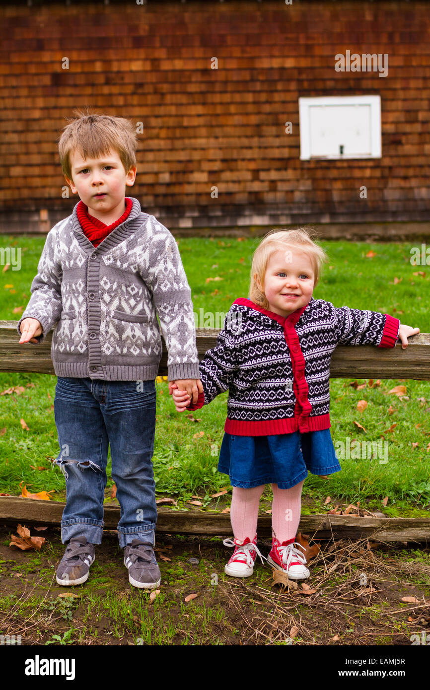 Fratello e Sorella in esterno e in una famiglia di moda stile di vita ritratto di due bambini. Foto Stock