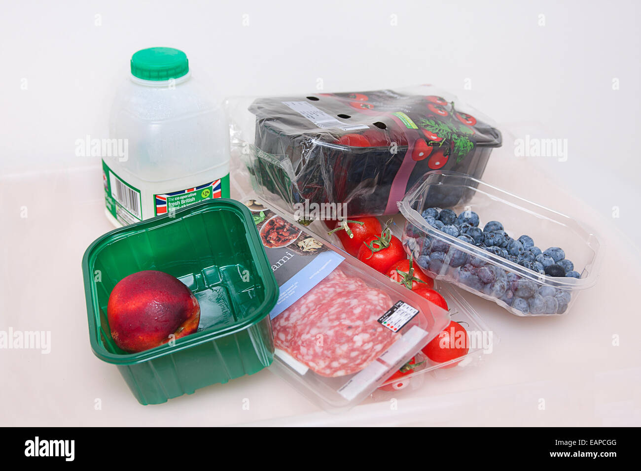 Assortimento di materiale plastico riciclabile e i colli contenenti frutta, verdura e latte Foto Stock