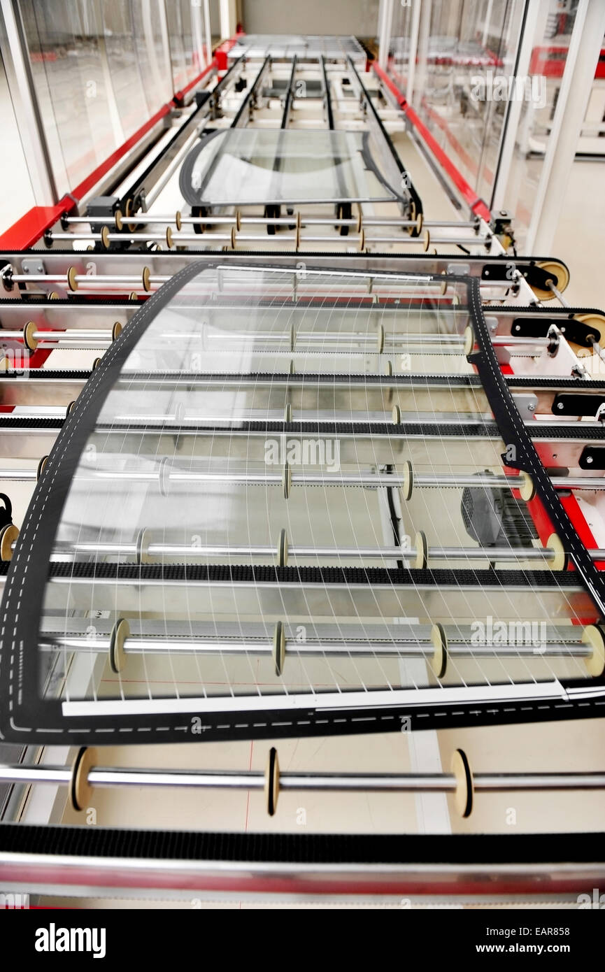 L'industria dettaglio con un posteriore vetro auto sulla linea di produzione in una fabbrica di vetro Foto Stock