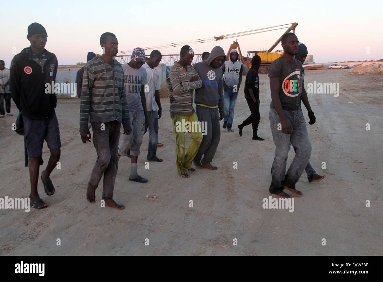 Garabulli, Libia. Xx Nov, 2014. Alcuni immigrati clandestini a piedi sul Seawall dopo essere stato salvato in Garabulli, la Libia, il nov. 20, 2014. Libia coast guard giovedì salvato decine di immigrati clandestini nei pressi della città costiera di Garabulli, una sessantina di chilometri da Tripoli. La Libia è stata per lungo tempo un punto di transito per gli immigrati che cercano di raggiungere Malta, l'Italia, e in altri luoghi in Europa a causa della sua prossimità e relativamente allentati del controllo di frontiera. © Hamza Turkia/Xinhua/Alamy Live News Foto Stock