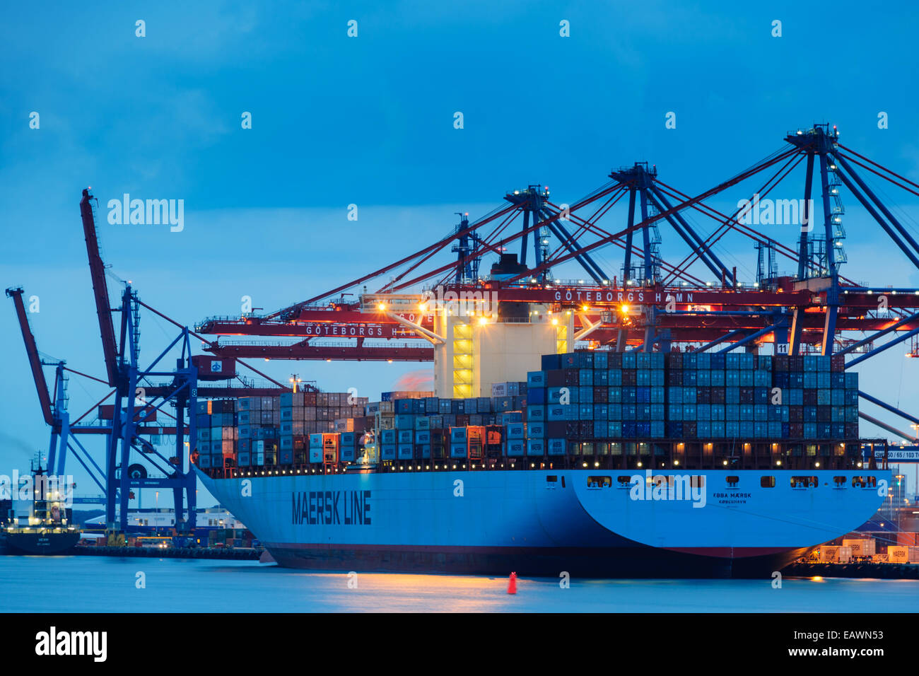 Grande nave adibita al trasporto di merci in un porto al tramonto Foto Stock