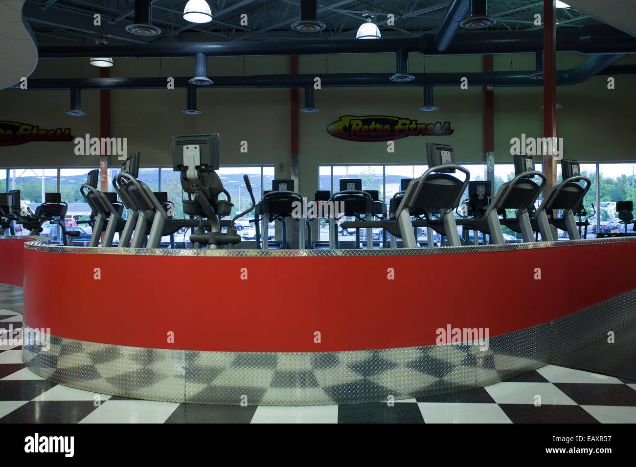 Moderno centro fitness presenta righe di tapis roulant in attesa per i clienti. Foto Stock