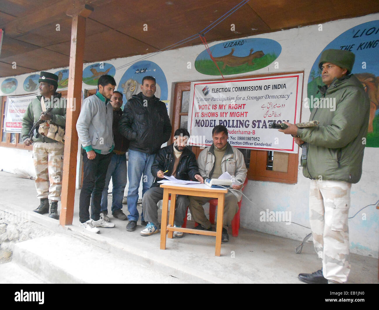 Srinagar Kashmir. 24 Novembre, 2014. Dipendente Goverrnment cheks voto elettronico macchina (EVM) come paramilitari indiano troopers guardia out polling laterale sia al distretto di ganderbal una ventina di chilometri da qui sicurezza potenziata sul primo gruppo di fase elezioni di domani 25 novembre. Credito: sofi suhail/Alamy Live News Foto Stock