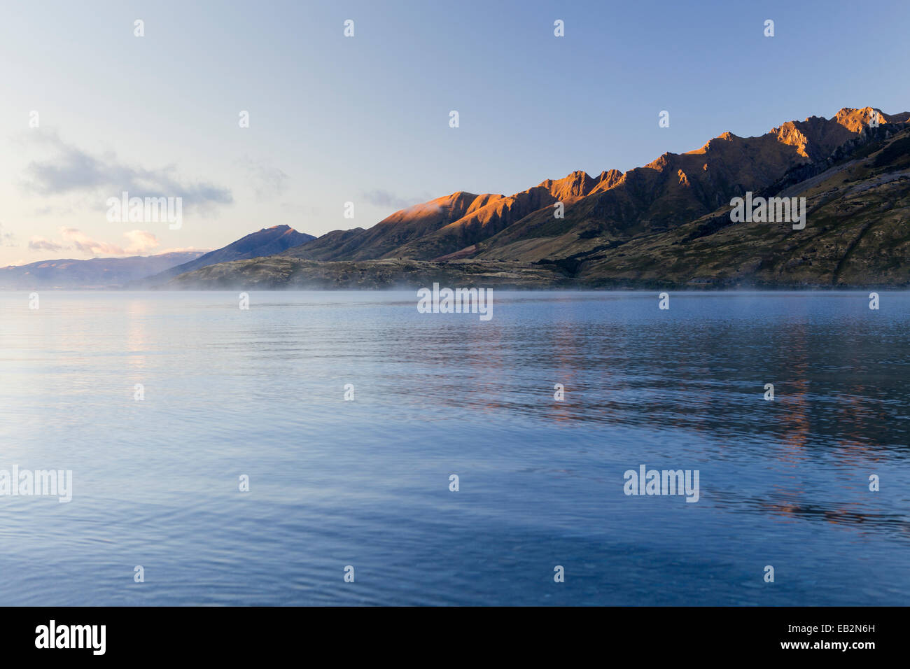 Nebbia sul lago Hawea, pendii montani nella luce del mattino, la Hunter Valley, Regione di Otago, Nuova Zelanda Foto Stock