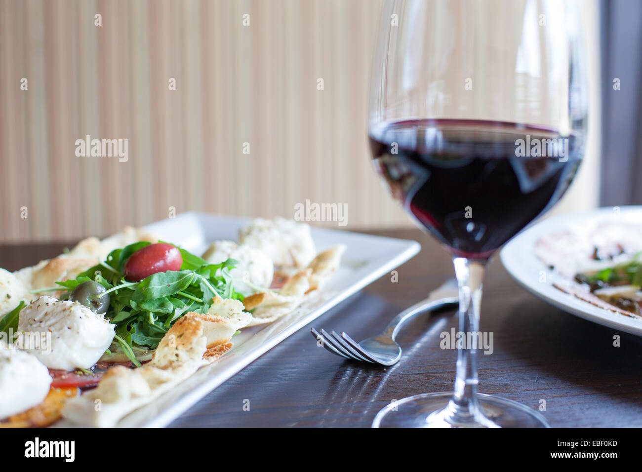 Antipasto Caprese con un bicchiere di vino rosso Foto Stock