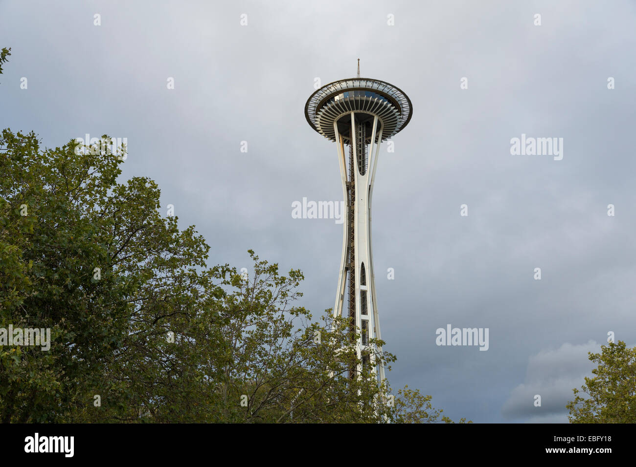 Seattle il famoso punto di riferimento, lo Space Needle, come si vede dalla vista sulla strada con una media, nuvole temporalesche in background Foto Stock