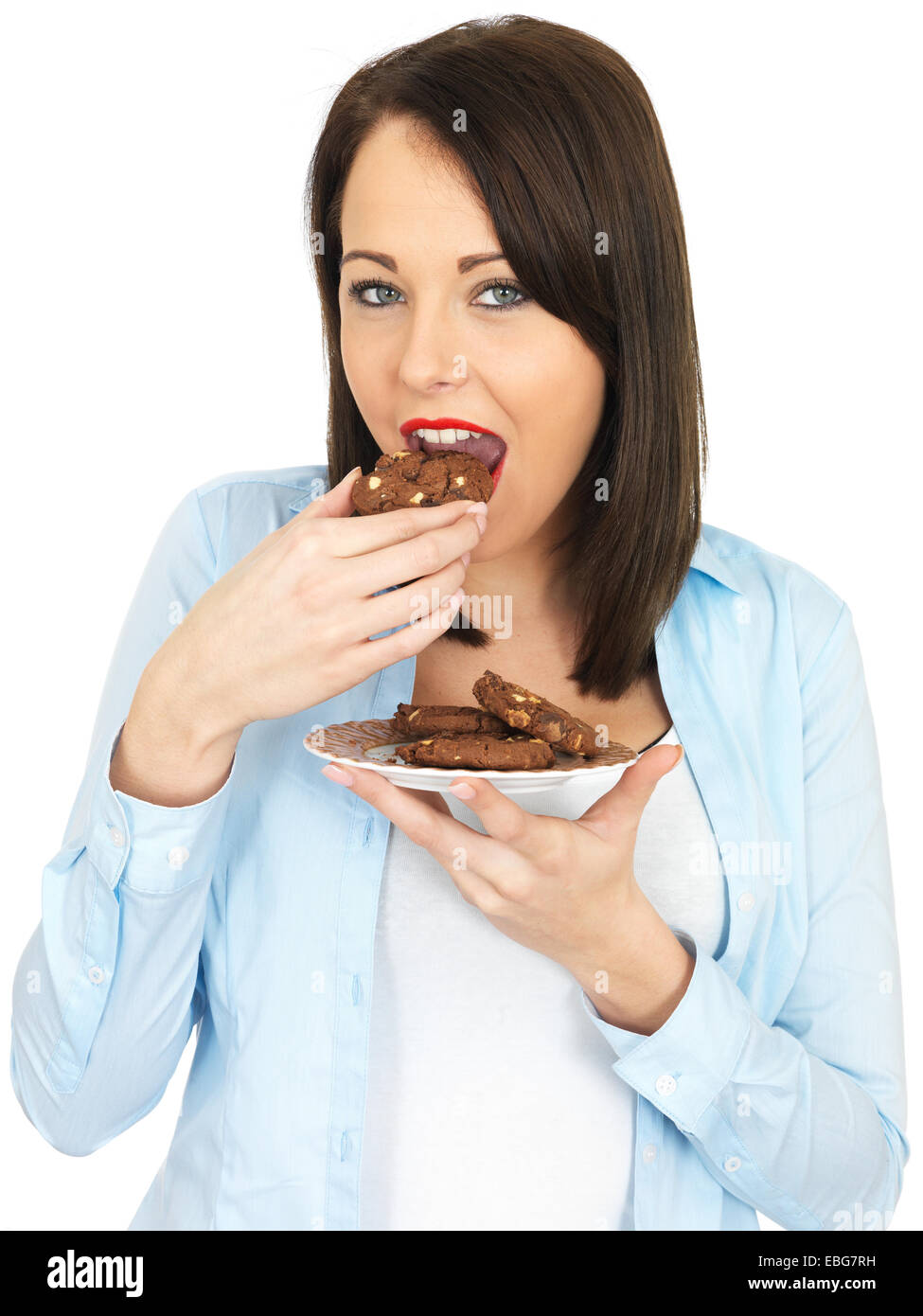 Attraente venti qualcosa di donna di mangiare i biscotti Foto Stock