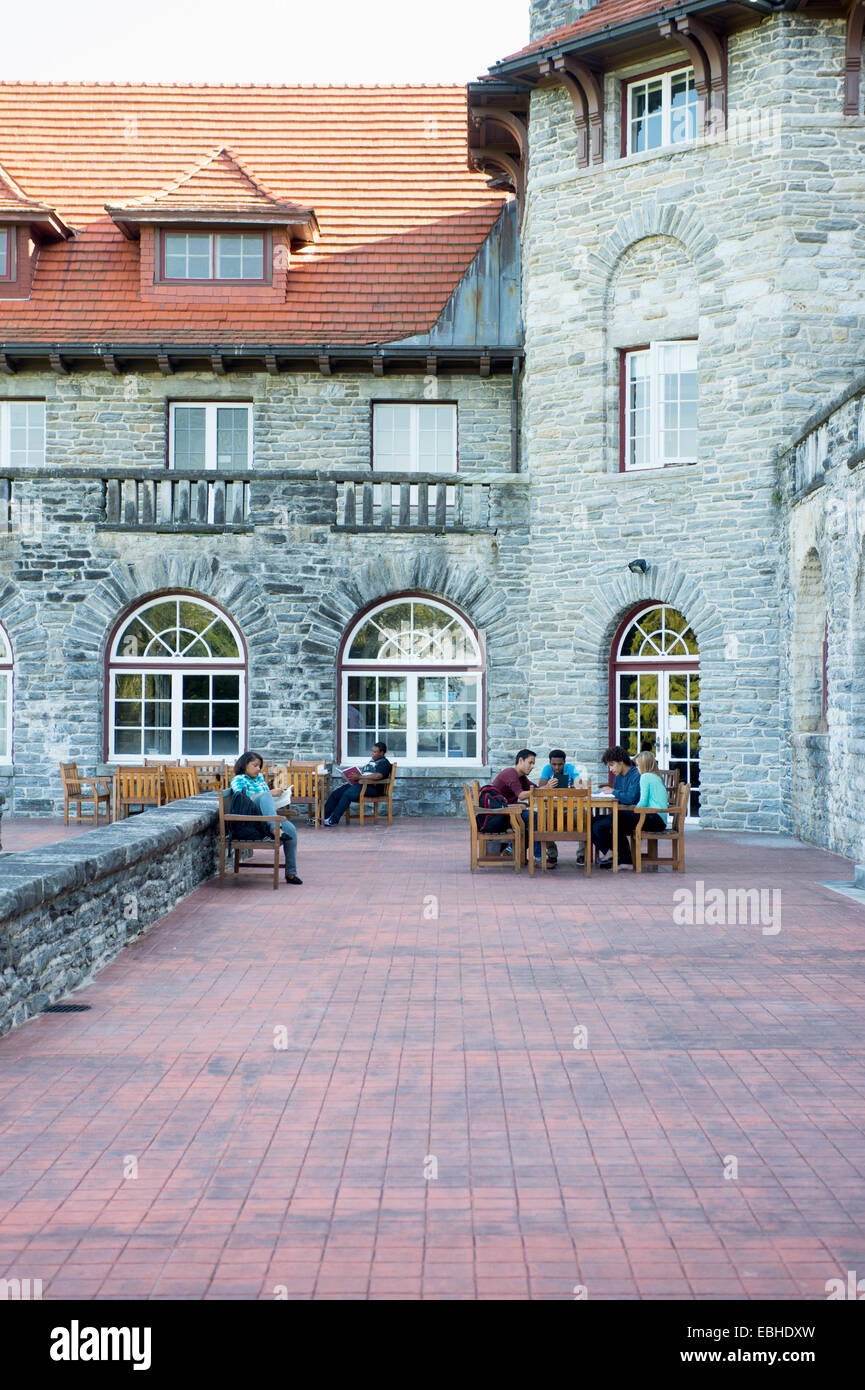 Gli studenti seduti sul patio esterno palazzo universitario Foto Stock