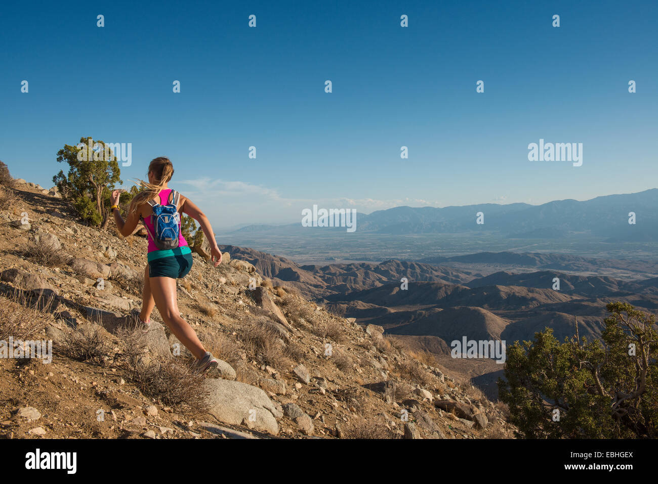 La donna in esecuzione sulla montagna, Joshua Tree National Park, California, US Foto Stock