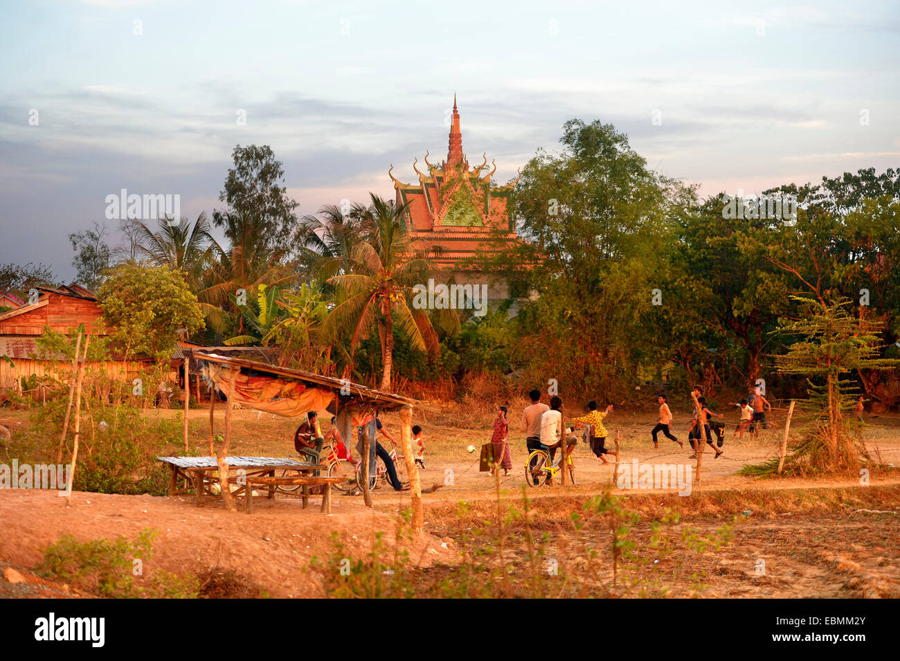 Ragazzi che giocano a calcio davanti a una pagoda, Bathi Distretto, Provincia di Takéo, Cambogia Foto Stock