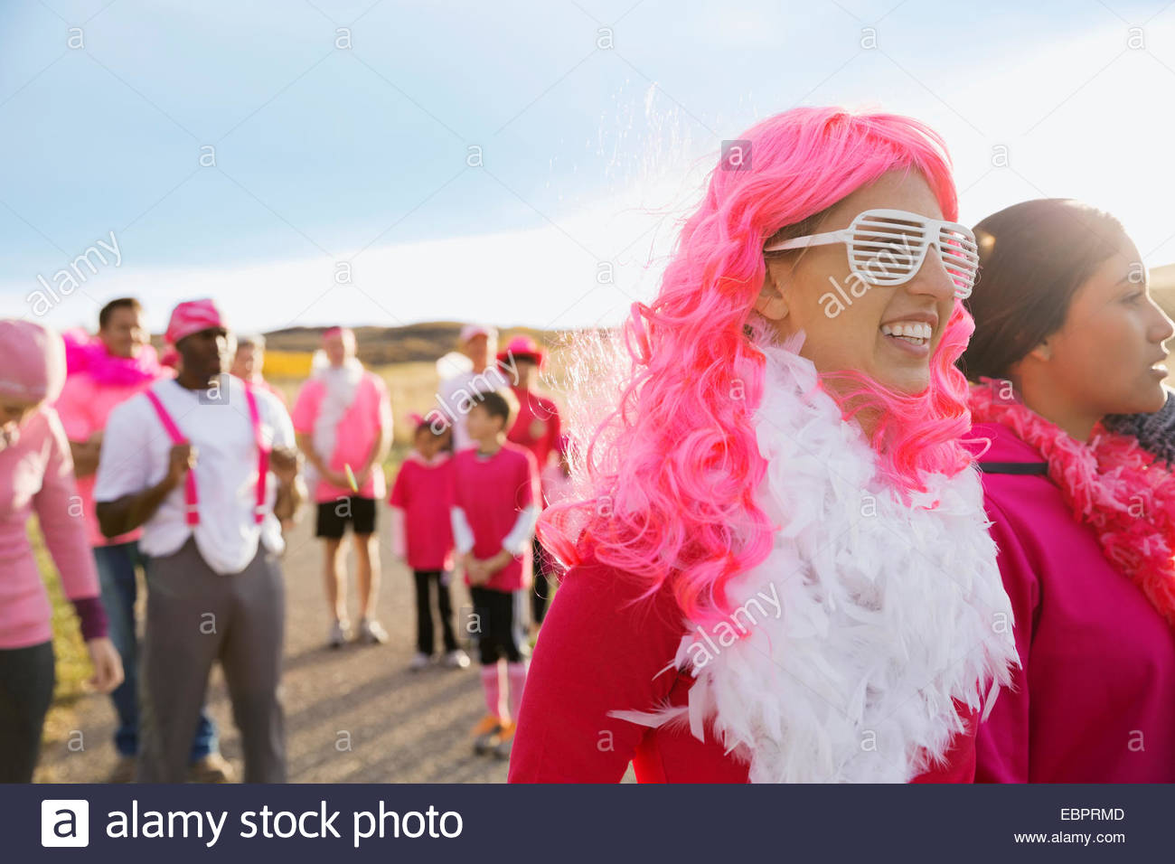 Donna in parrucca rosa che partecipano nella gara di carità Foto Stock
