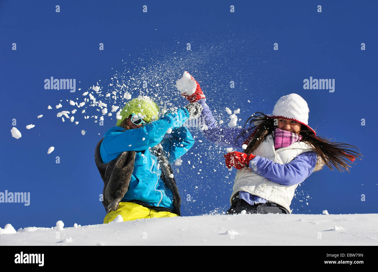 Due giovani ragazze frolicly combattimenti nella neve, Francia Foto Stock