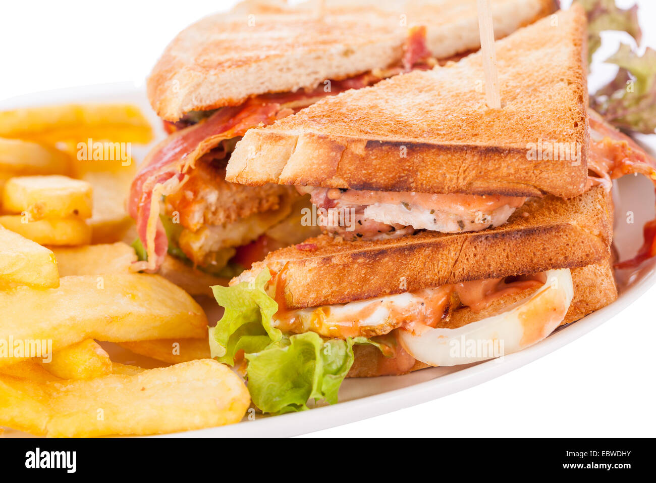 Club sandwich a tostare il pane bianco con un ripieno di carne servita con croccante di patate dorate patatine fritte, closeup vista parziale isolato su bianco Foto Stock