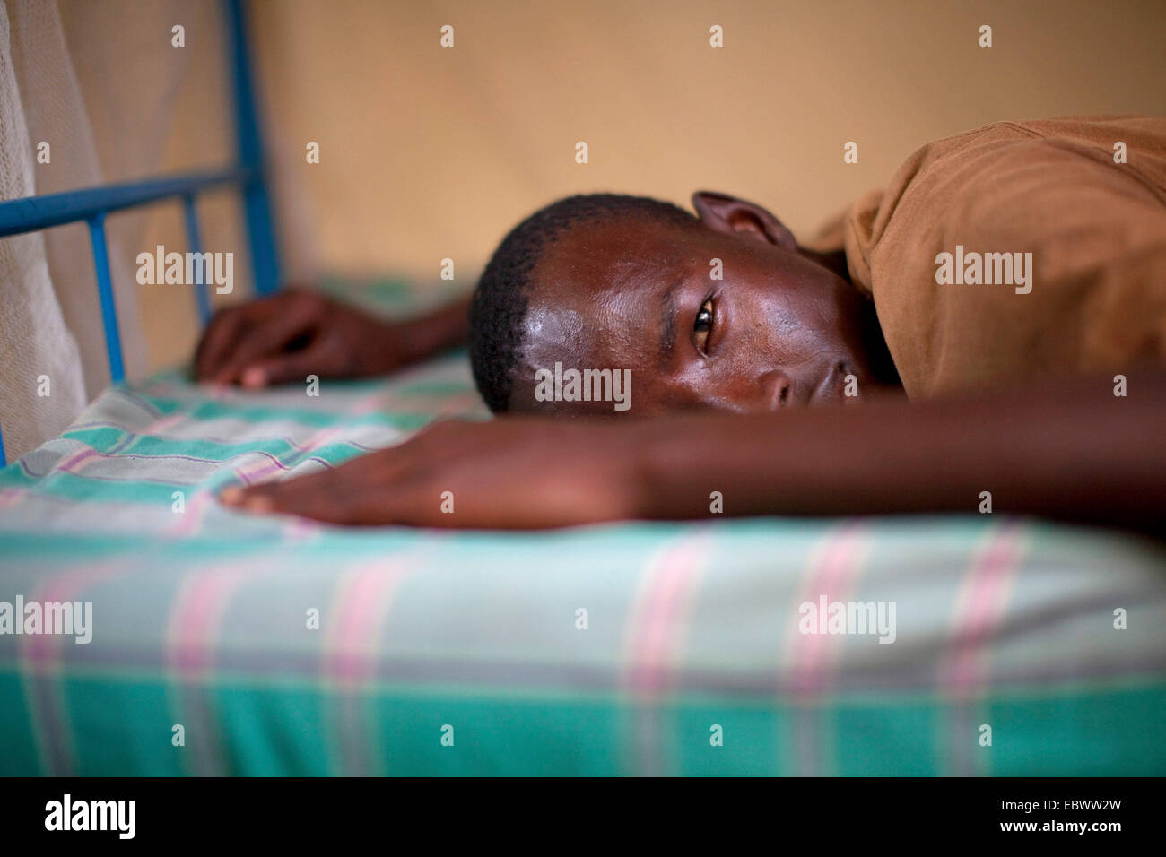 Ritratto di un giovane uomo disteso su un letto, Burundi Bujumbura Foto Stock