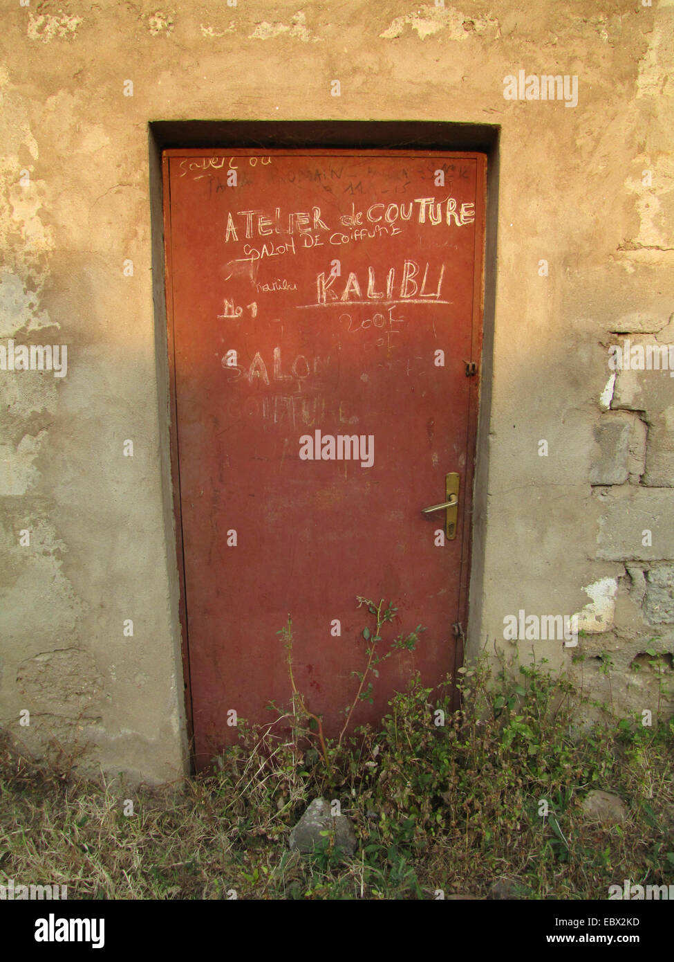 Chalk la scrittura su una porta di metallo annunciando un negozio di sartoria, Burundi Bujumbura mairie, Kiriri Bujumbura Foto Stock