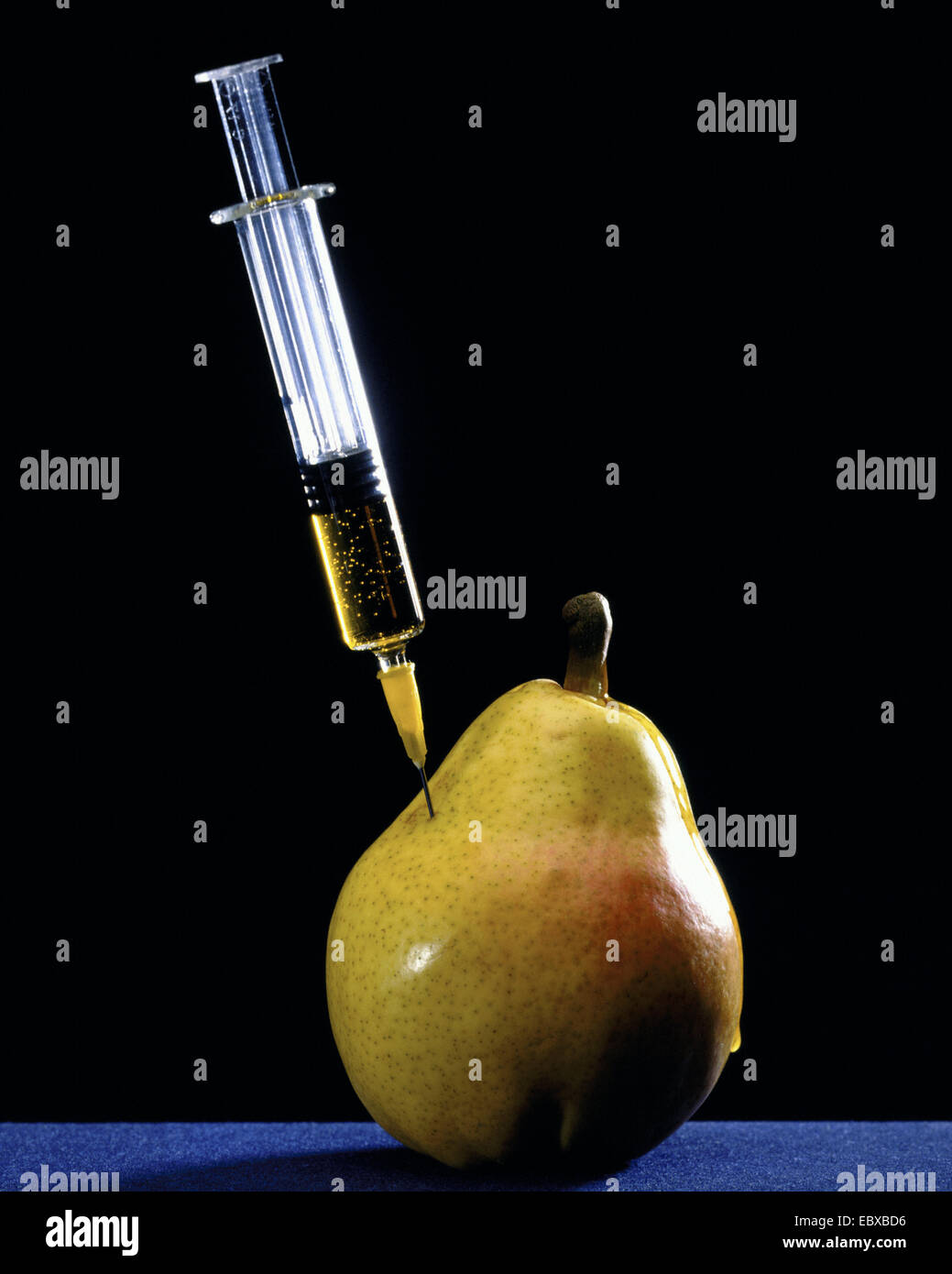 Iniezione in una pera, immagine simbolica per gen cibo Foto Stock