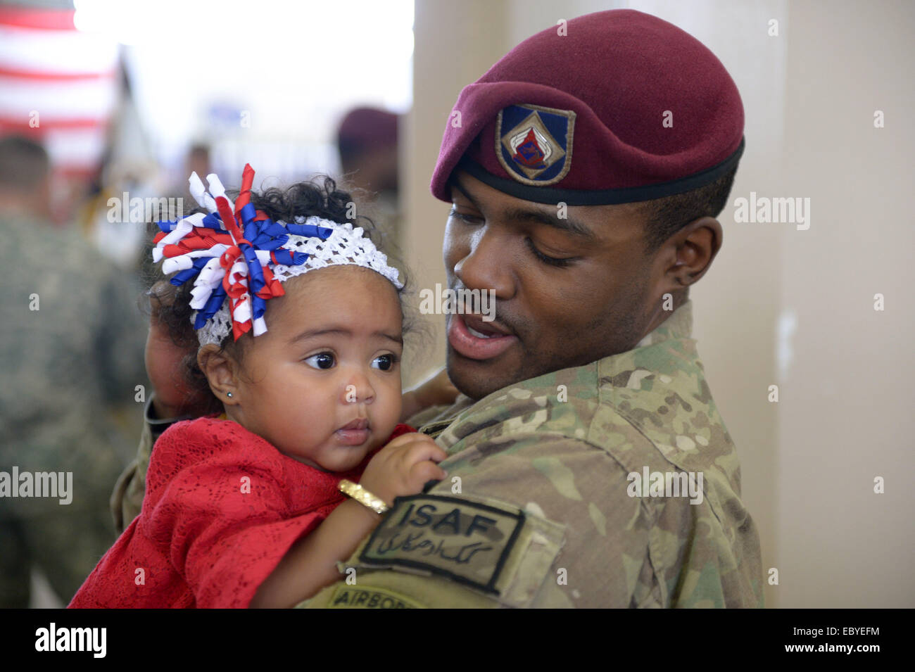Fort Bragg, STATI UNITI D'AMERICA. 5 Dic 2014. Un paracadutista restituito da Afghanistan mantiene la sua figlia in braccio a Fort Bragg, North Carolina, Stati Uniti, Dicembre 5, 2014. Circa 100 i paracadutisti sono arrivati a casa dopo che viene dispiegato in Afghanistan per 11 mesi. Credito: Yin Bogu/Xinhua/Alamy Live News Foto Stock