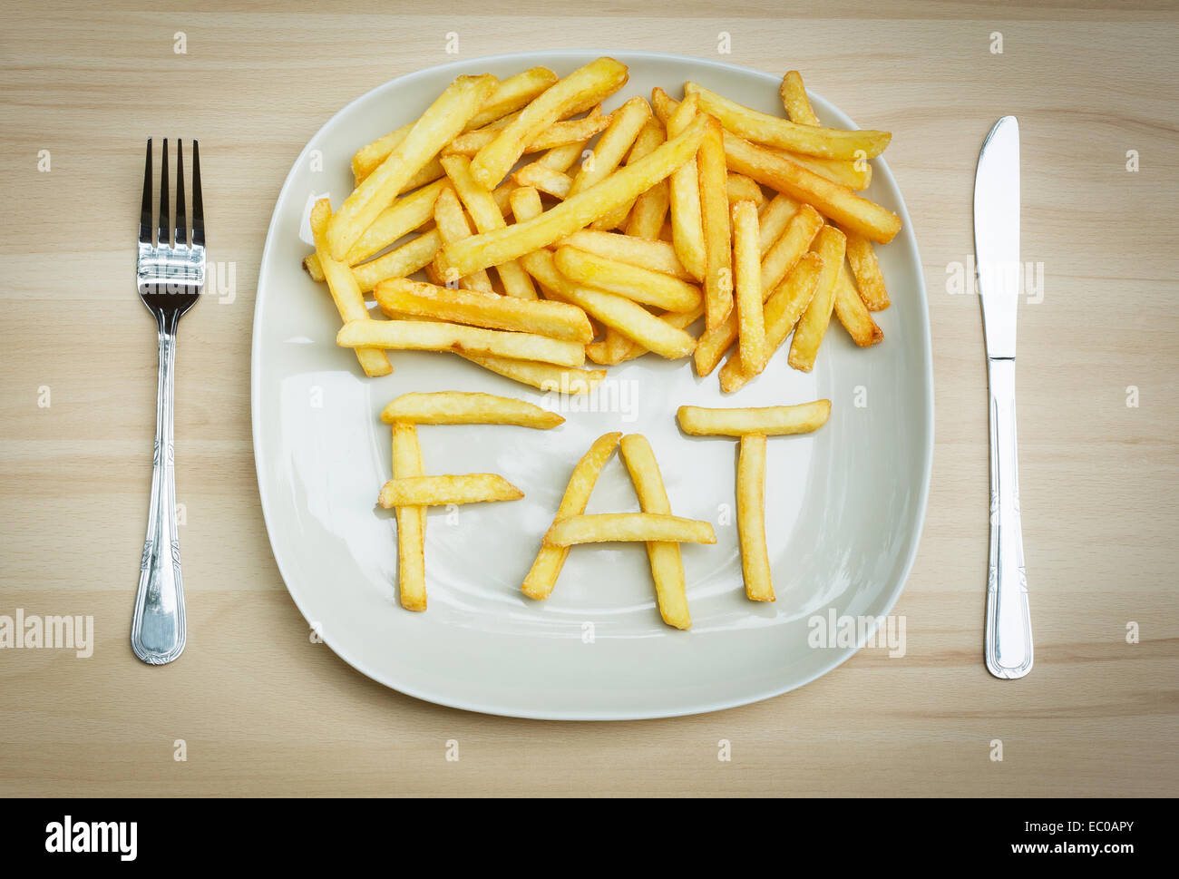 Cibo malsano concetto - le patatine fritte su una piastra Foto Stock