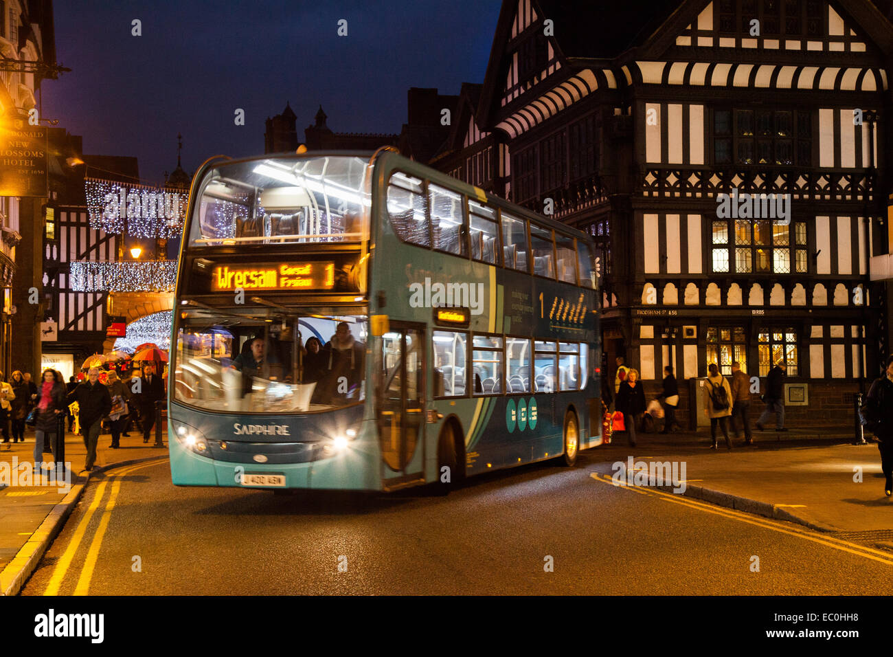 Gli autobus del trasporto pubblico per le strade di Chester, Cheshire; centro città paesaggio serale vacanze di Natale stagione di shopping, negozi al dettaglio, negozi. Regno Unito Foto Stock