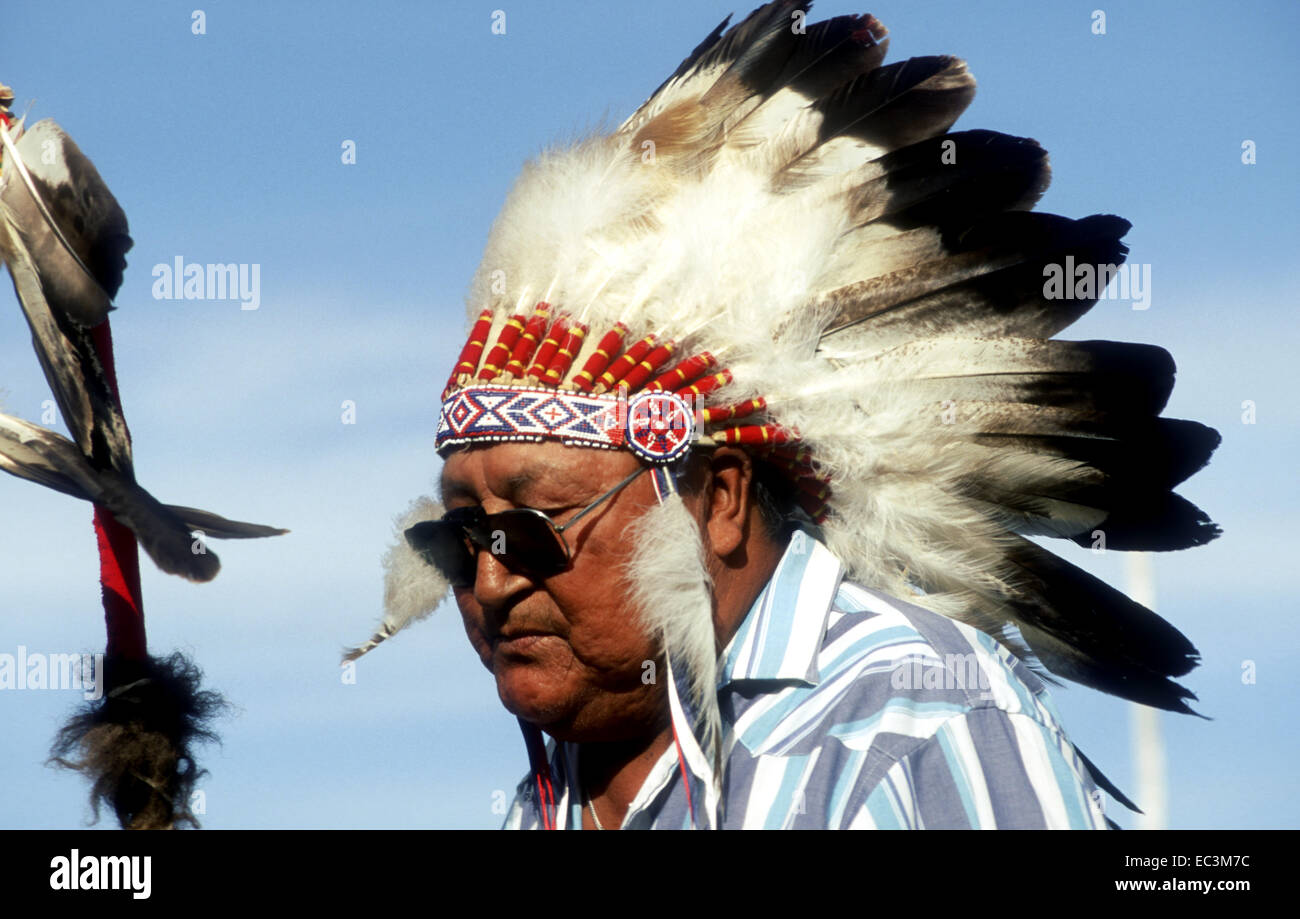 Lakota Chief con Feathered copricapo e occhiali da sole Foto Stock