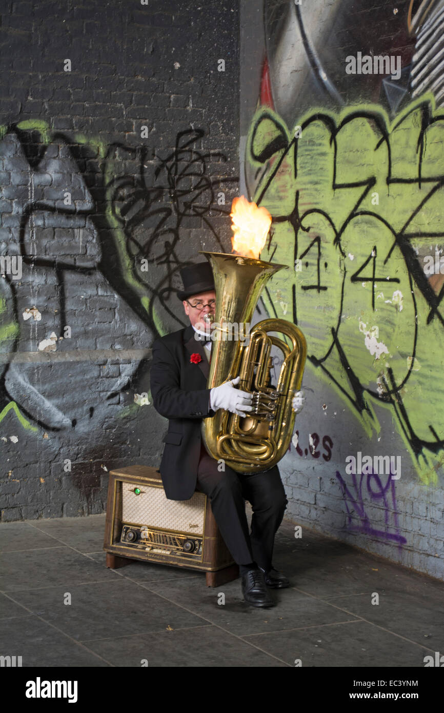 Animatore di strada con fiamma Novità gettando Tuba nella City di Londra, Inghilterra, Regno Unito Foto Stock