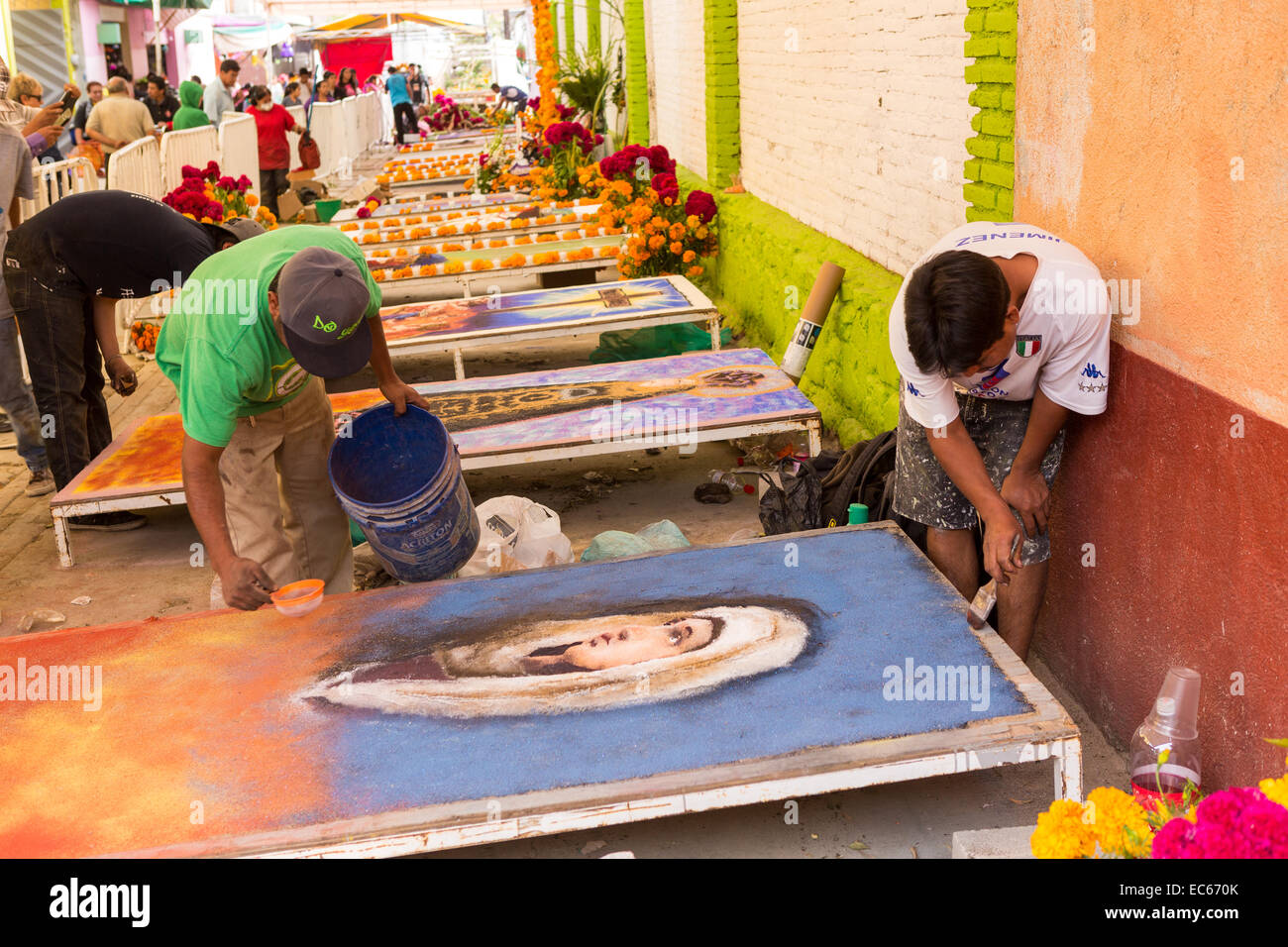 Artisti messicani creare elaborare la pittura con la sabbia durante il giorno dei morti festival noto in spagnolo come d'un de Muertos al vecchio cimitero Ottobre 31, 2014 in Xoxocotlan, Messico. Foto Stock
