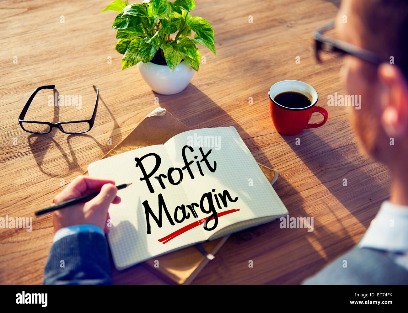 Uomo con una nota e una parola del margine di profitto Foto Stock