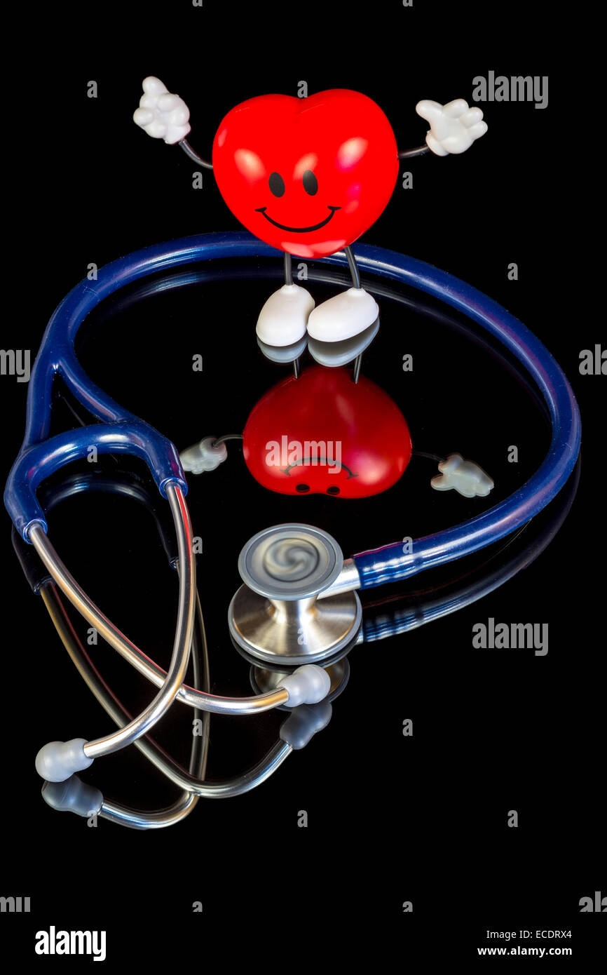 Lo stetoscopio e un cuore felice Foto Stock