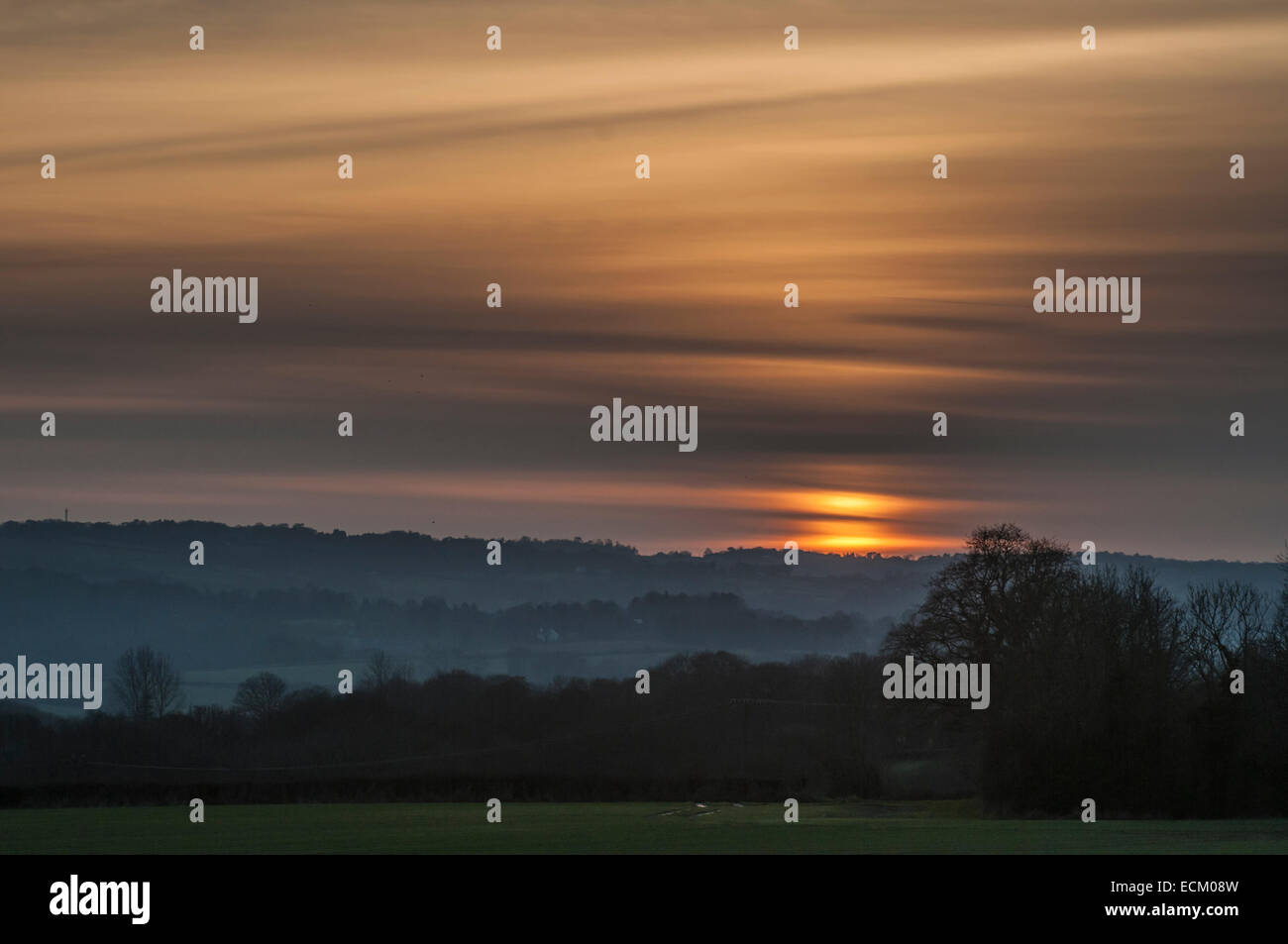 StoneGate, East Sussex, UK.16 Dicembre 2014.Mist formando nella Rother Valley e le alte nuvole fanno un morbido tramonto pastello sulla splendida Campagna del Sussex. Foto Stock