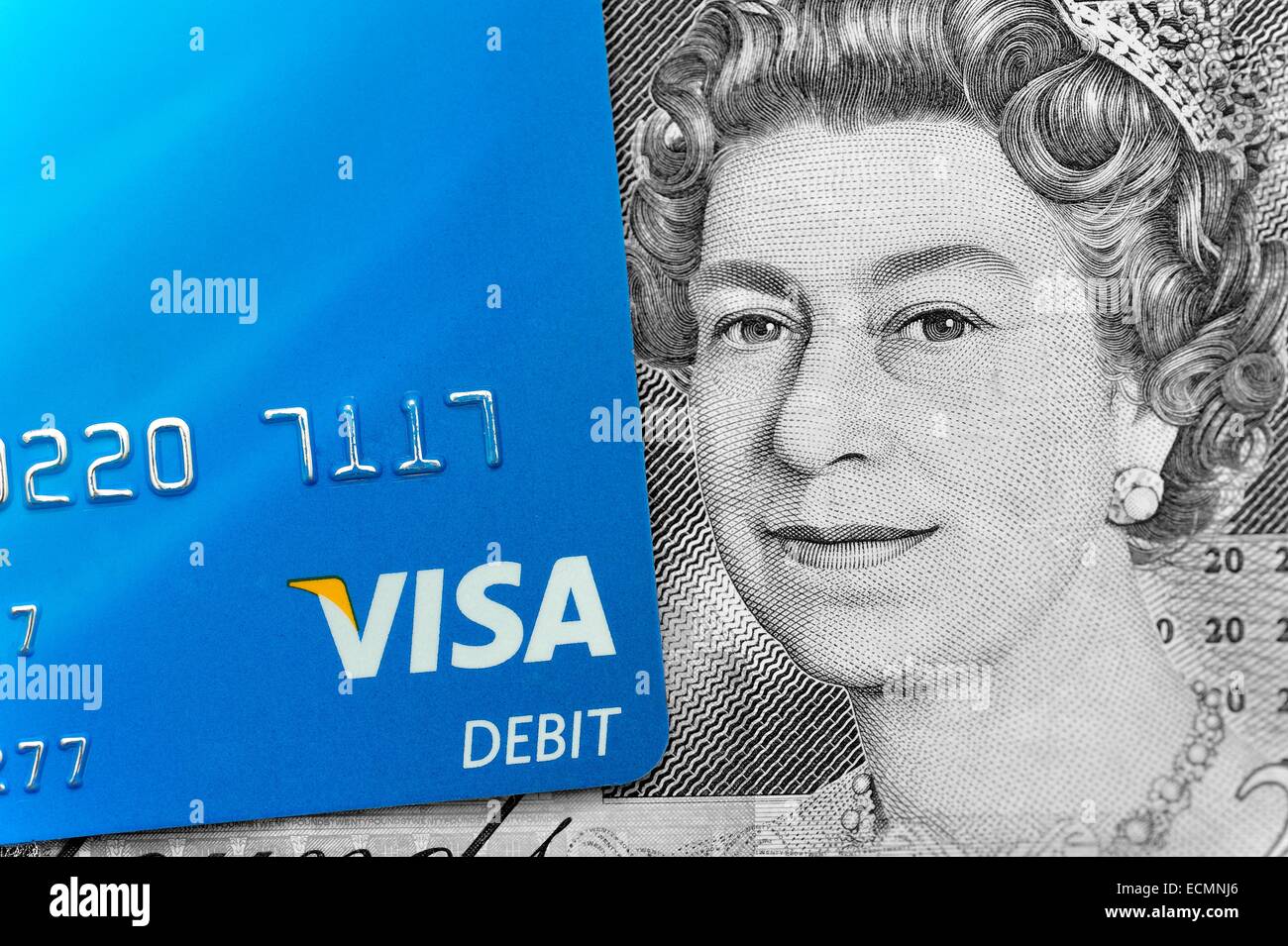 Una Visa Debit Card accanto al Queens Head da venti una sterlina inglese nota banca Inghilterra REGNO UNITO Foto Stock