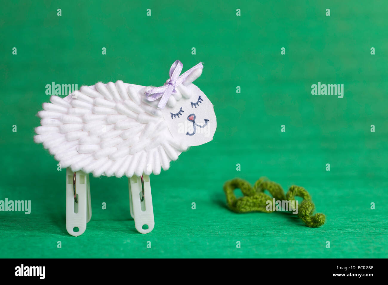 Bianco fatti a mano giocattolo di pecora su sfondo verde Foto Stock