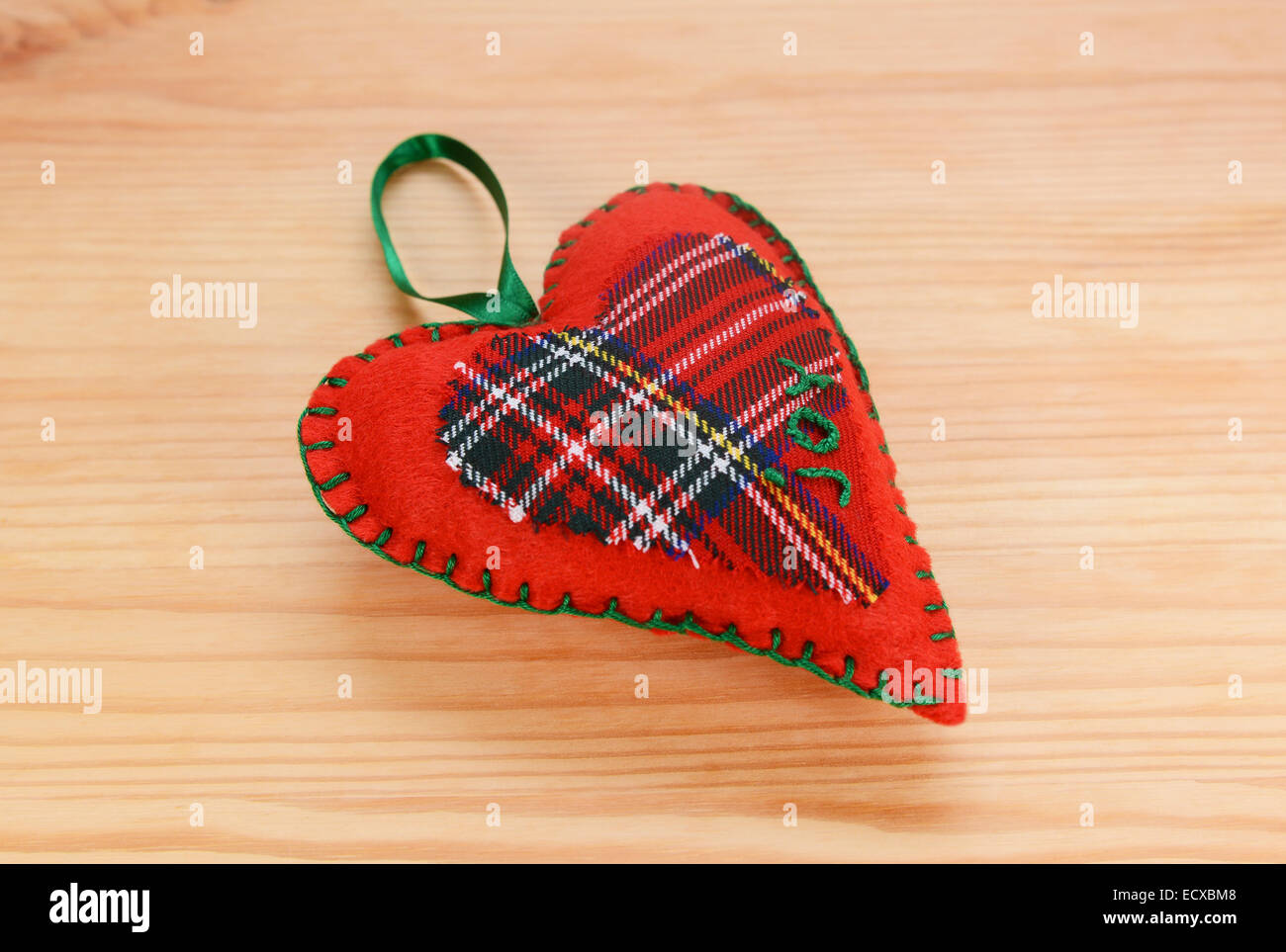 Fatte a mano in tartan rosso a forma di cuore decorazione di Natale, cucita con la parola gioia Foto Stock