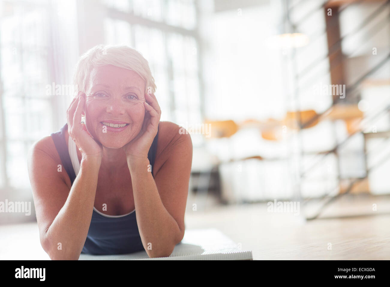 Donna anziana rilassante sul pavimento Foto Stock