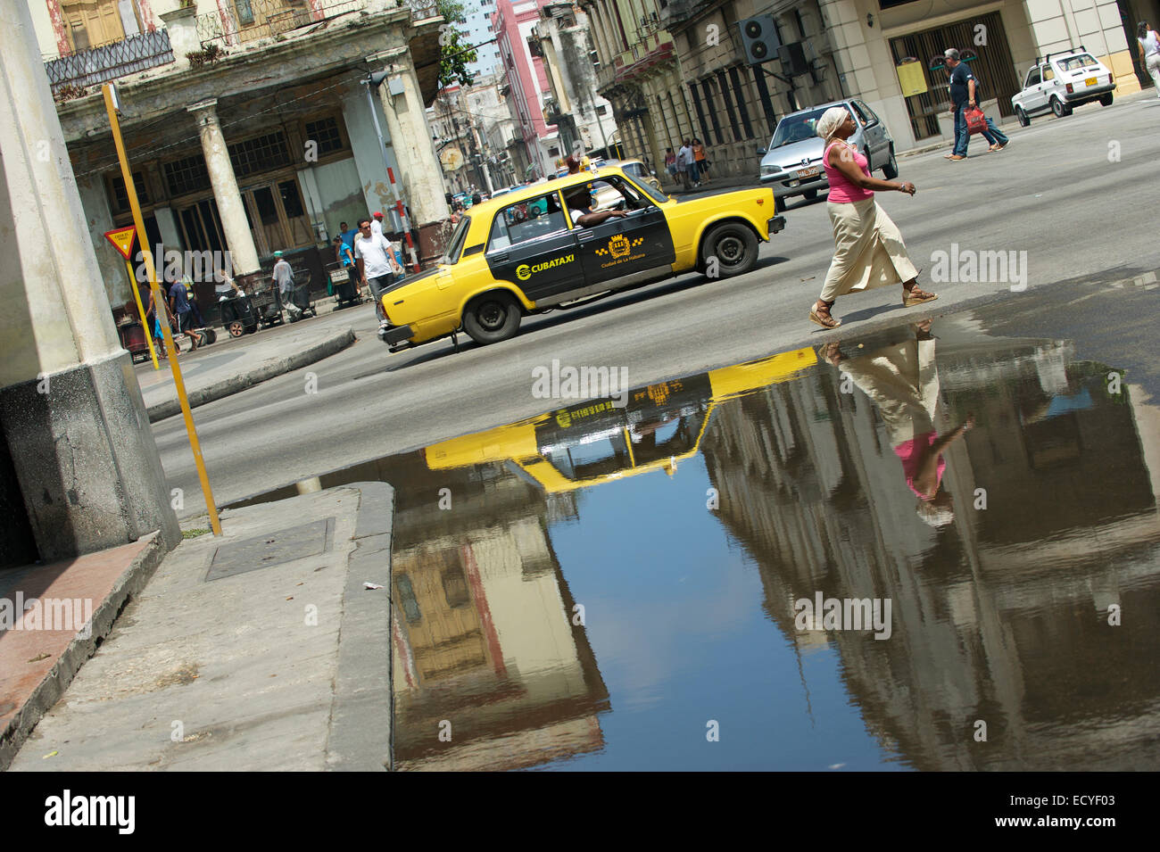 L'Avana, Cuba - Giugno 13, 2011: vecchio stile in bianco e nero e giallo taxi Lada passa i pedoni su una strada nel centro di Avana. Foto Stock